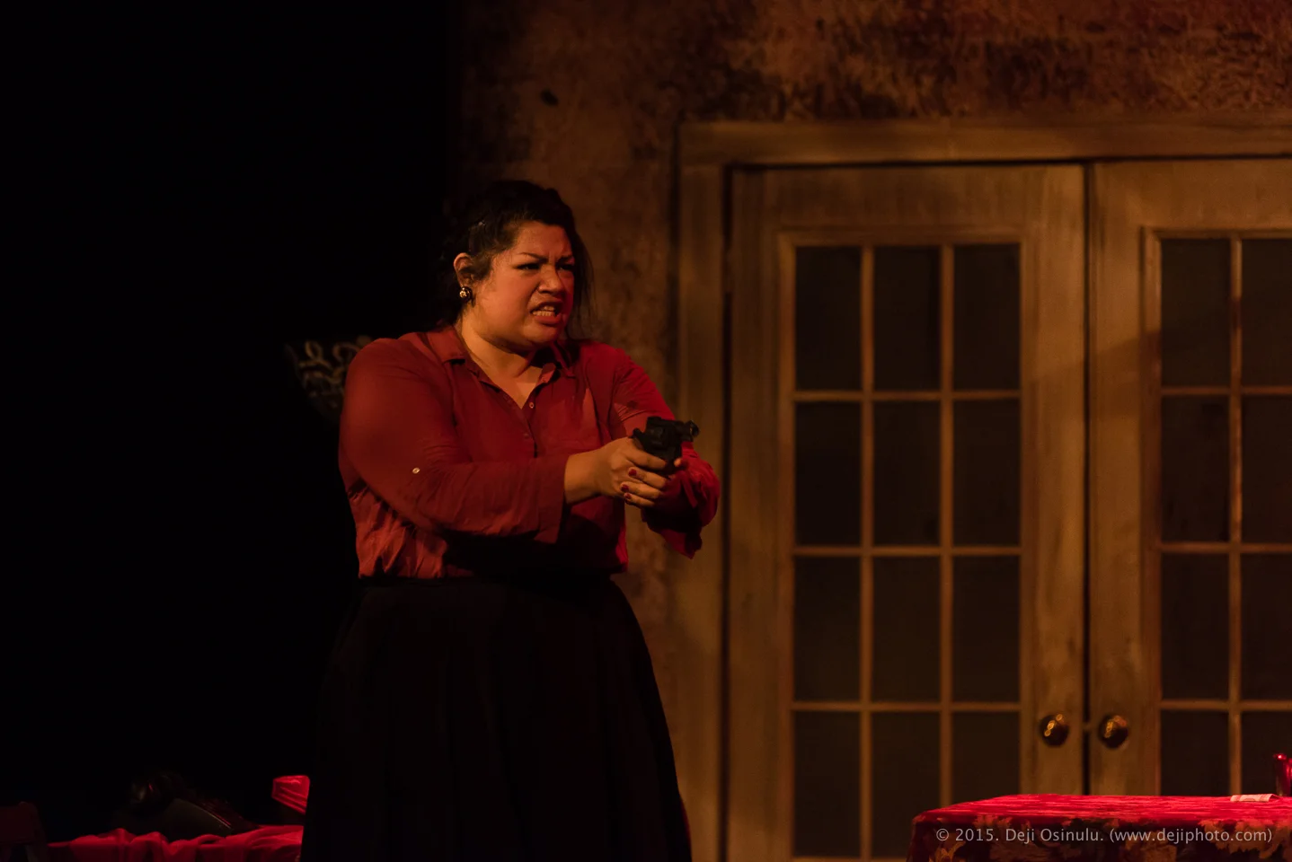 Mezzo-soprano Claudia Chapa packing heat as Madame Flora in Opera in the Heights' THE MEDIUM. © Deji Osinulu Photography