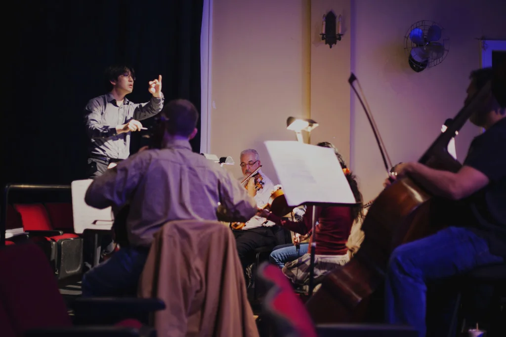 Opera in the Heights’ Principal Conductor Eiki Isomura is shown here during a rehearsal for La tragedie de Carmen in 2015. Photo by Mariam Khalili
