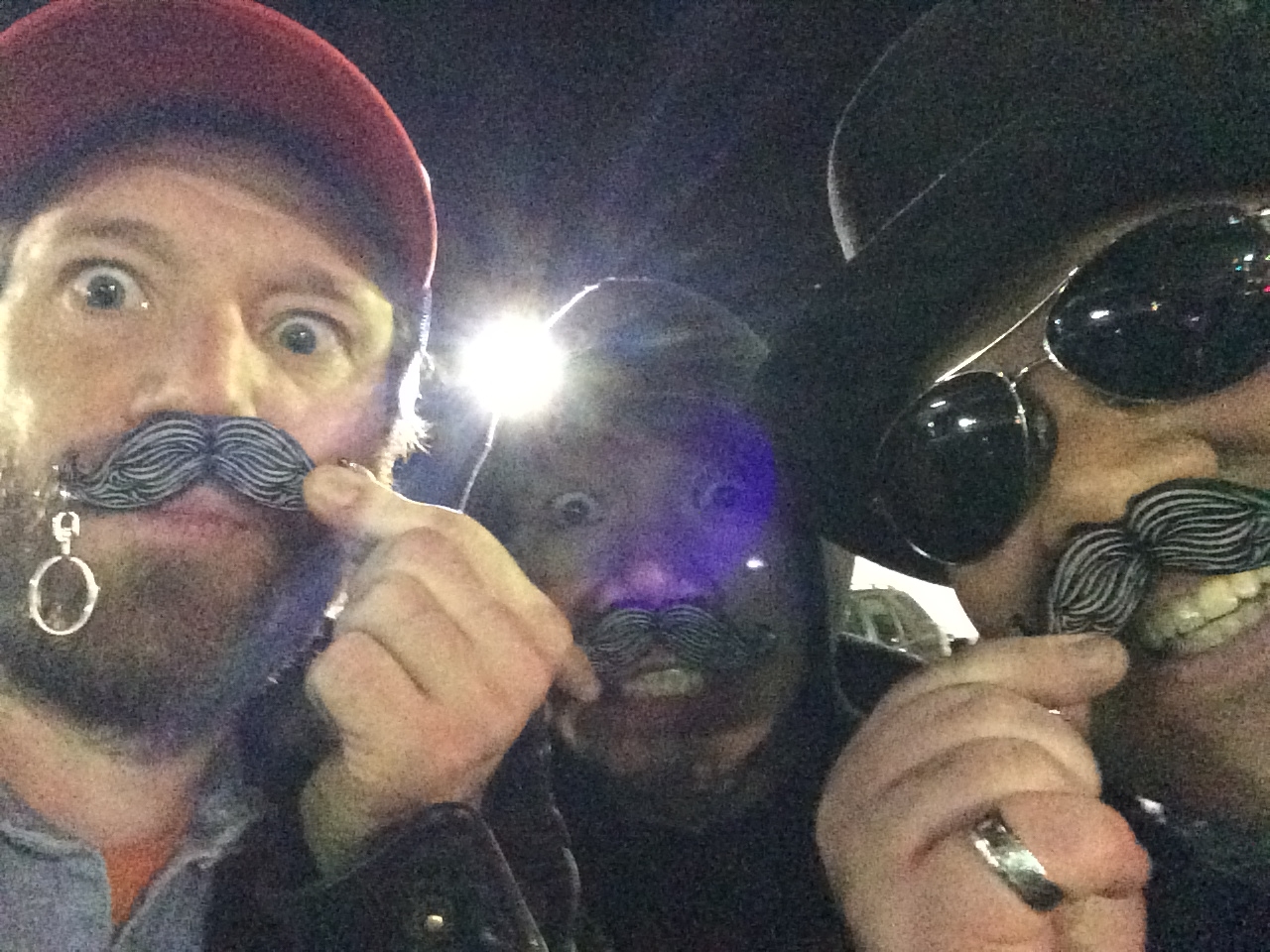 Graeme Hinde, Eric Volfango, & Manny Decoria pose with fake mustaches after a corporate event at Bardot in Hollywood.