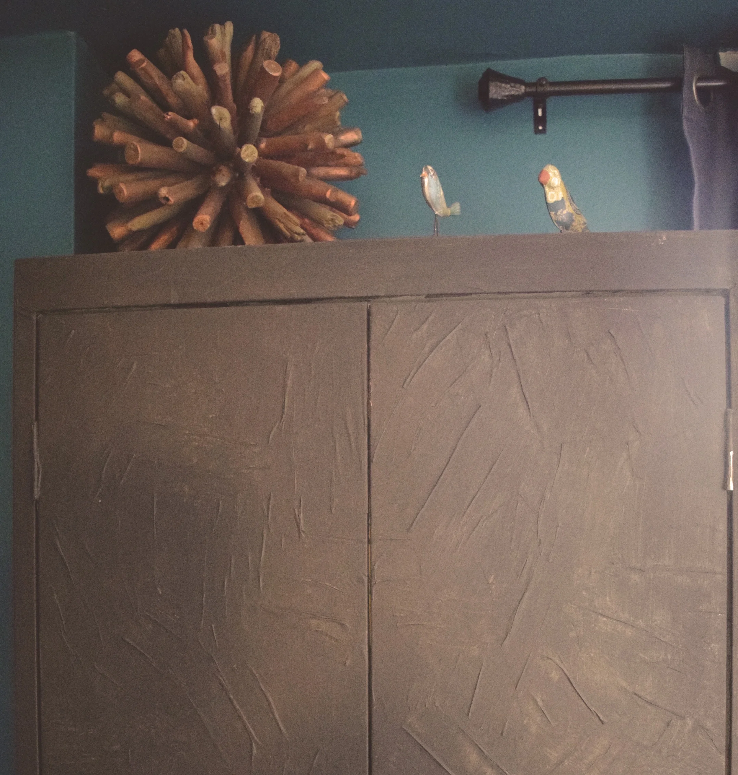 Close up: By decoupaging this cabinet I added a layer of texture, and by painting over the paper I created a slightly distressed look that adds character to this now unique piece.
