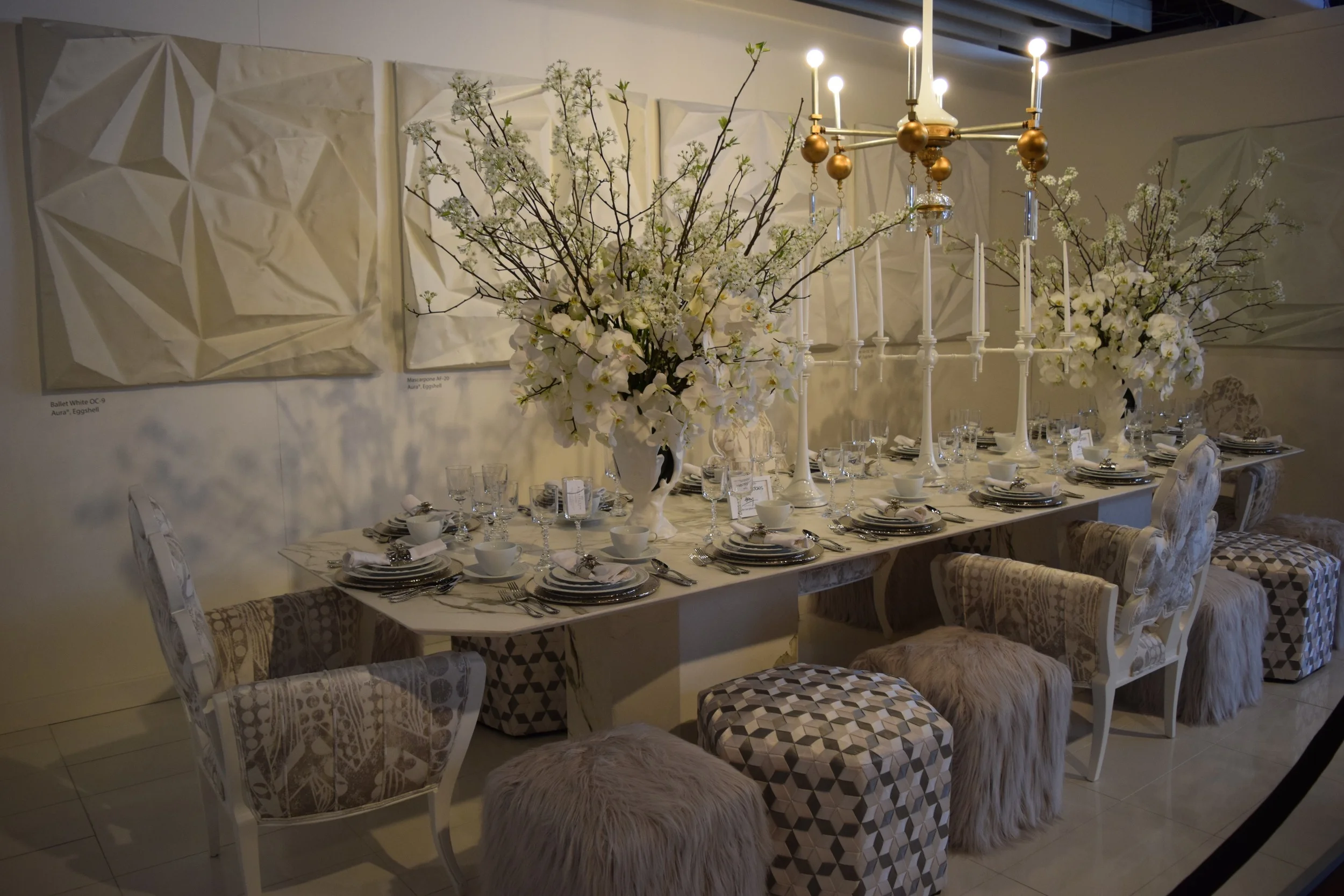 "The great Paris fashion houses have been Julia Buckingham's muse. Our space is reminiscent of a long, flowing silk-charmeuse white gown with sparkling chandelier earrings; chunky lacquered bracelets; and a strikingly modern sculptural necklace hidden under a snow-white fur wrap."