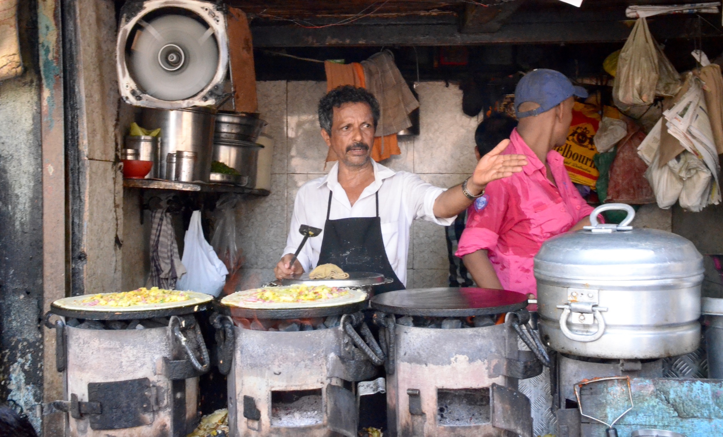A storeowner points to his next customerY