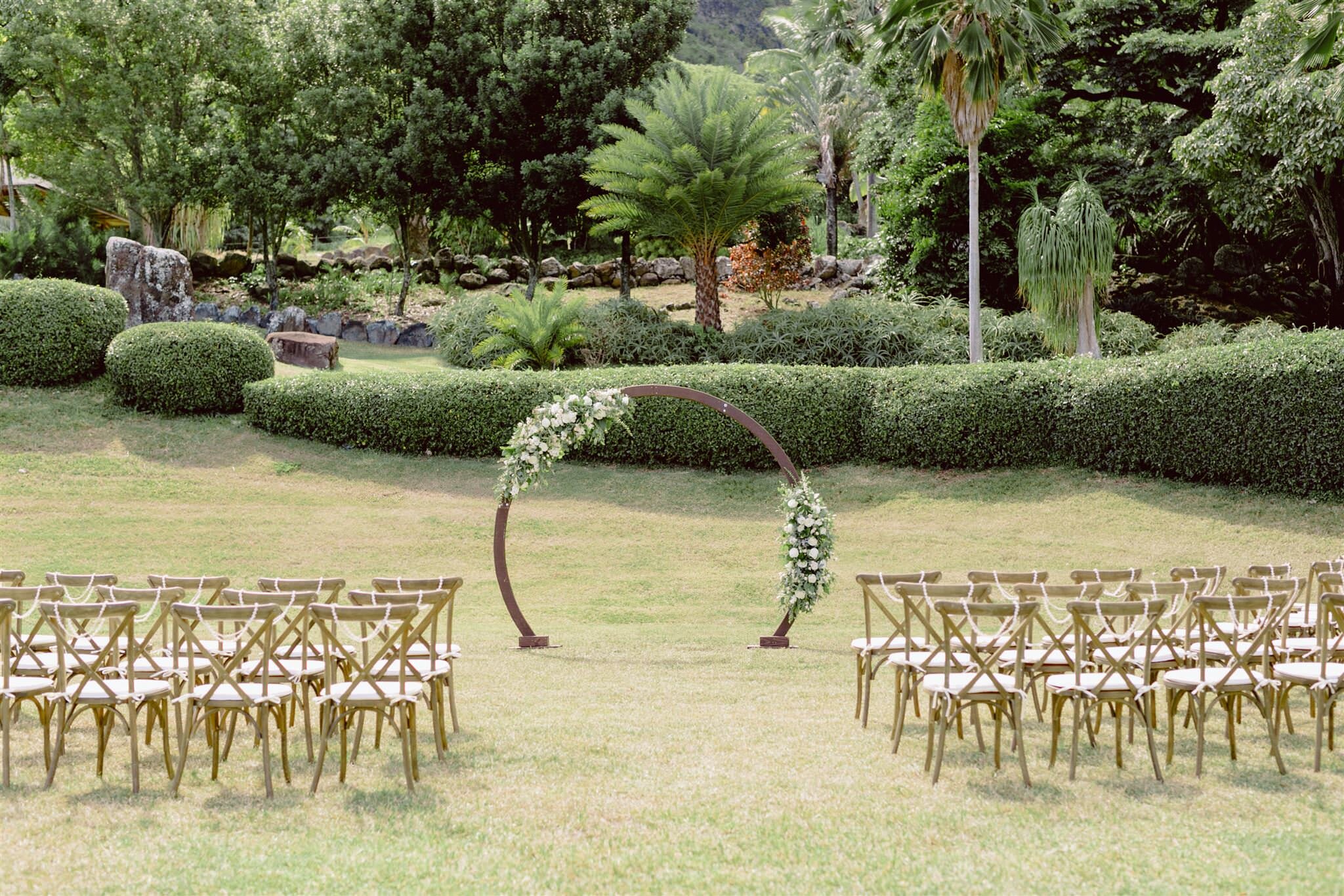Paliku-Gardens-Kualoa-Ranch-Hawaii-Wedding-Photographer-ceremony-arch-arbor-chairs