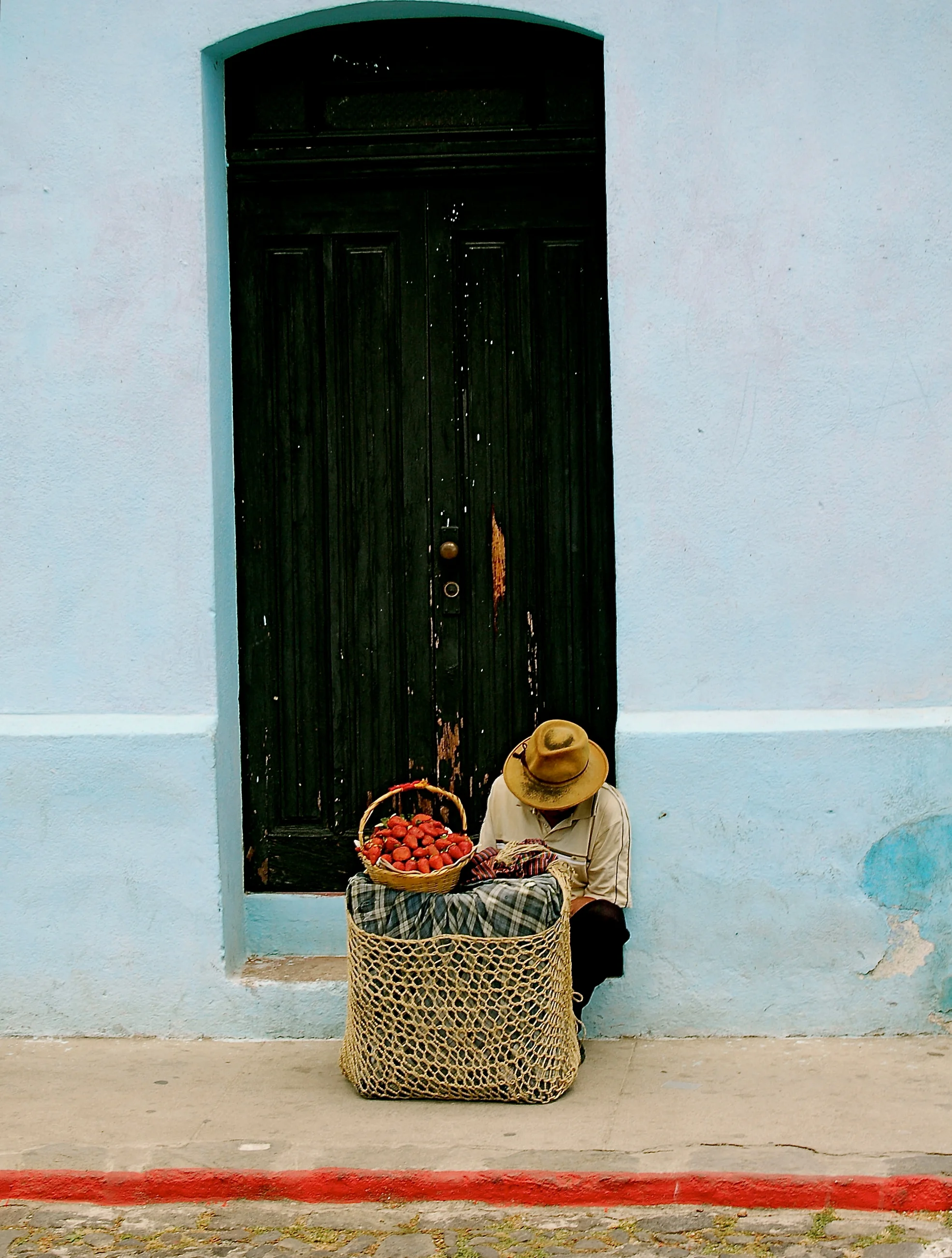   Oaxaca  - A fruit vendor takes a break from selling fresh strawberries to a neighboring town. 