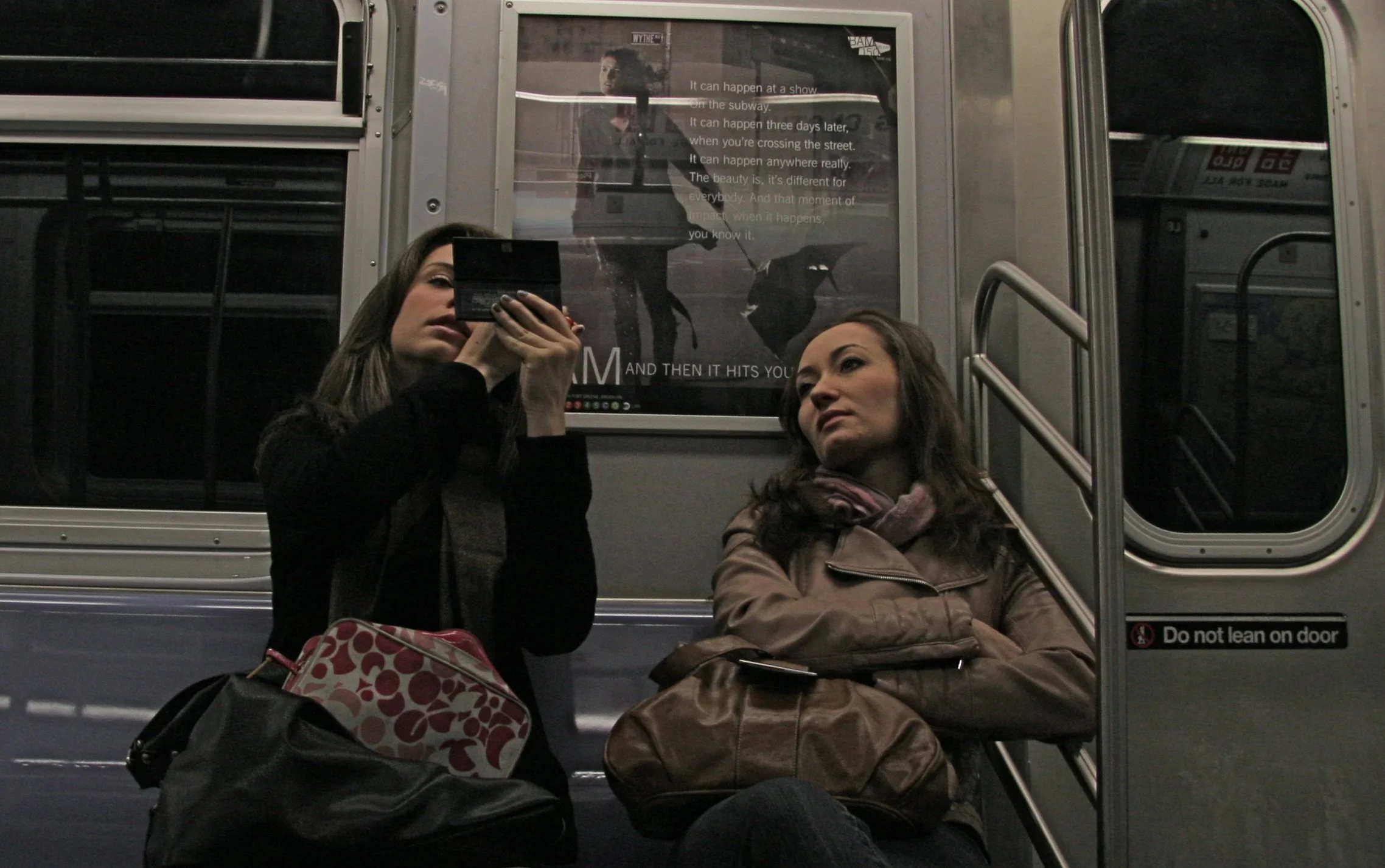  NYC. Two hours after sunset. Two women are seen on a train bound for uptown Manhattan. Both women are seemingly in their own worlds. As one applied her confidence the other sat in thought. 