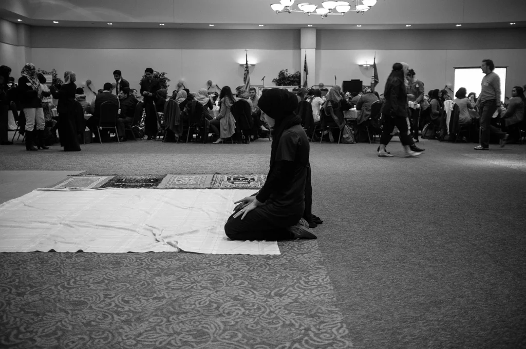 A Georgia State University student prays before grabbing a meal at the Fast-a-Thon hosted by the Muslim Student Association. 