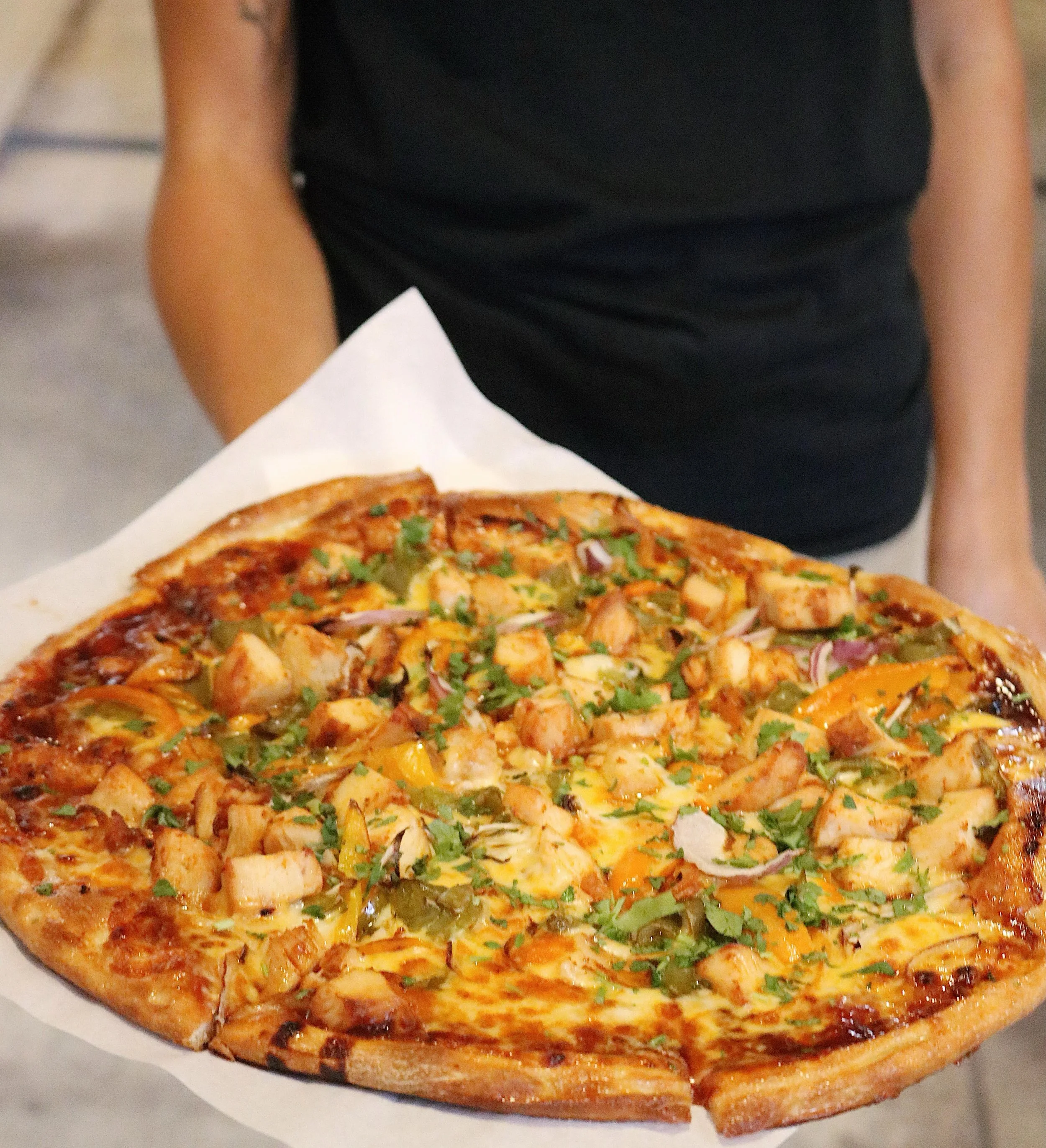 Fresh out of the oven and looking real good today. 😍🍕Our Chipotle BBQ Chicken starts with our freshly made dough, Restraint Chipotle BBQ Sauce, mozzarella &amp; smoked cheddar cheese, bell peppers, red onion, BBQ chicken, and topped with cilantro. 