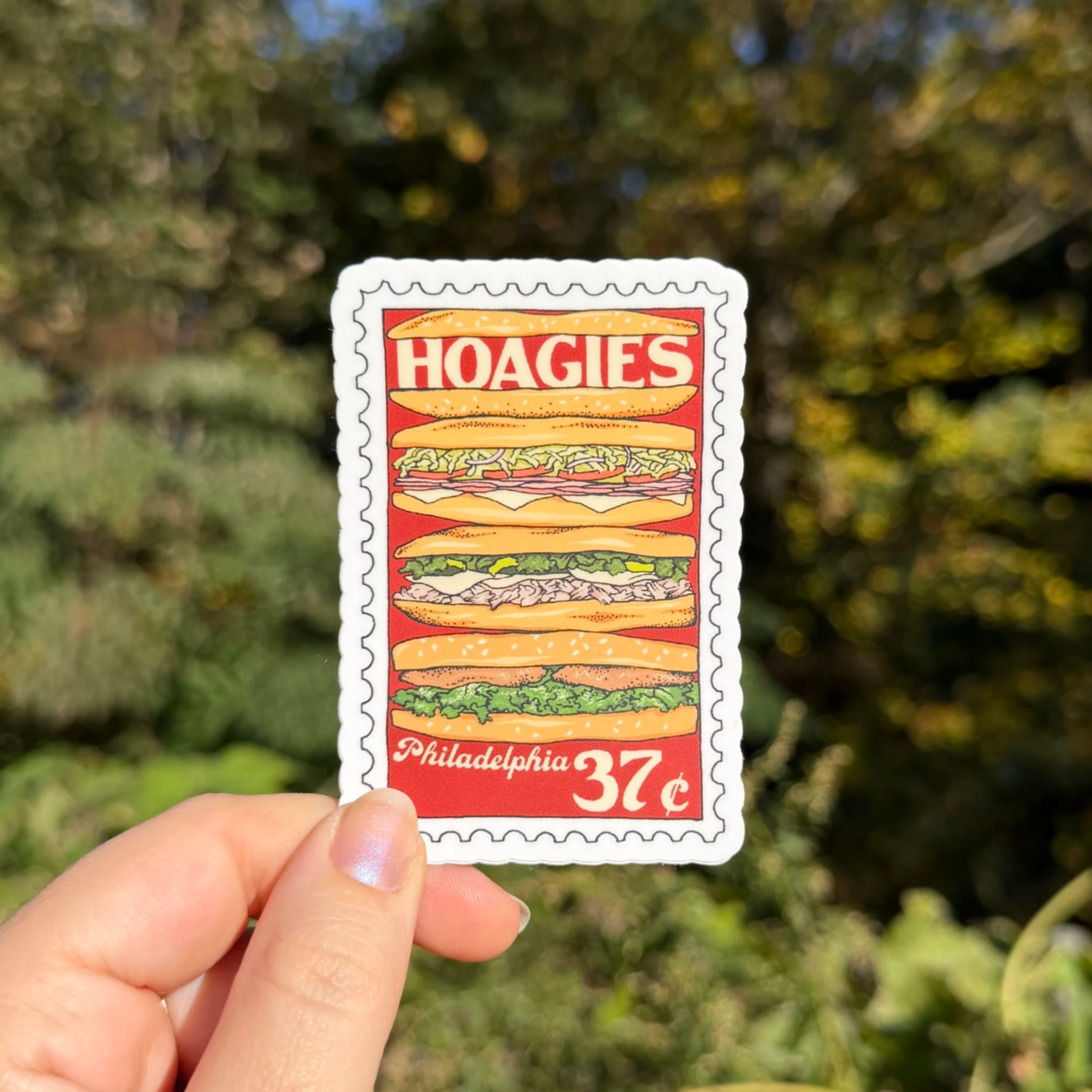 Stamp sticker featuring illustration of stack of hoagies and "Philadelphia"