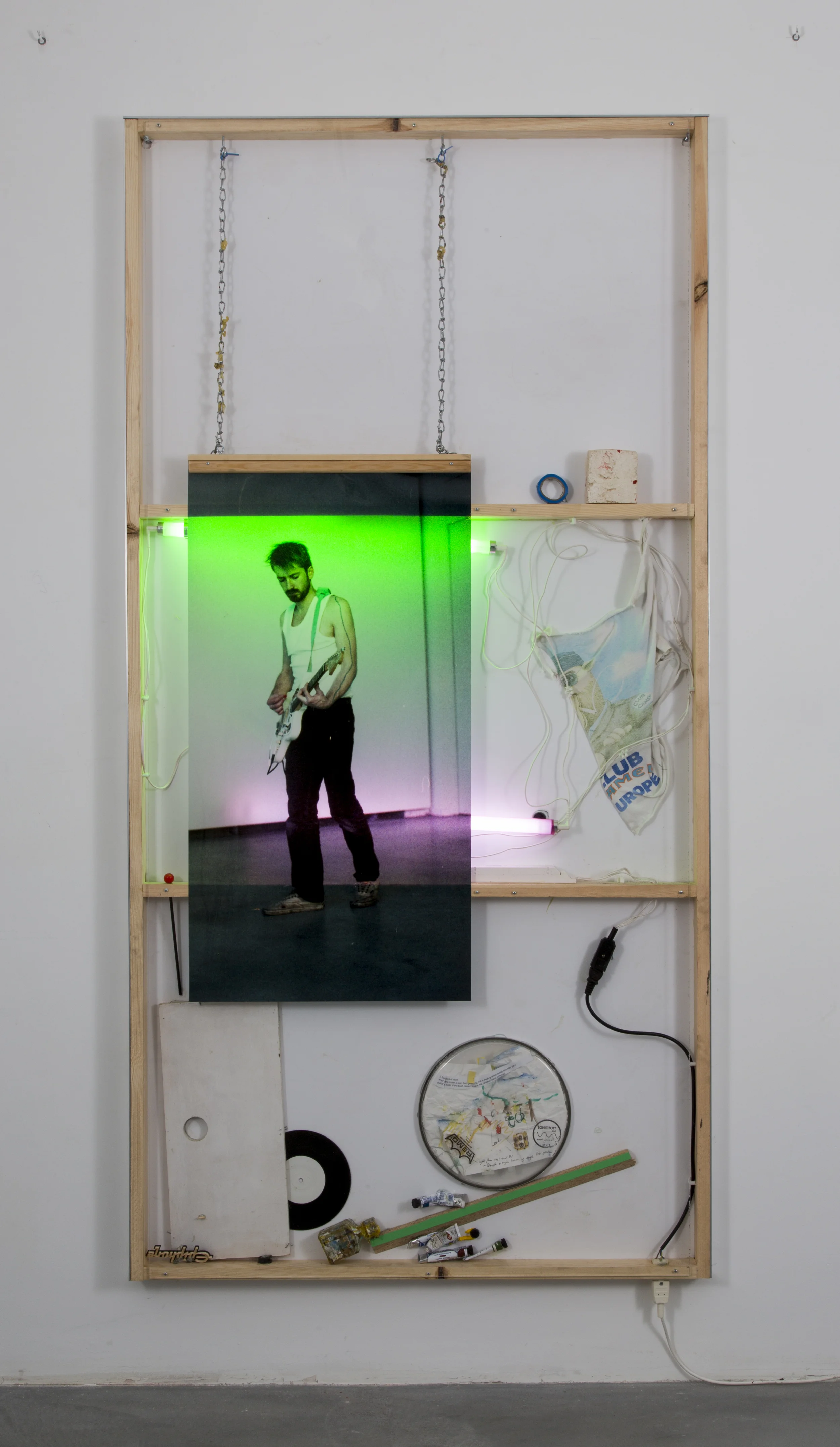 Joris Van de Moortel , The cyclic character of playing through a repetition of the same fragment, me, KB Berlin (2015). 78.95 x 39.75 x 2.2 inches. Wood, Plexiglass, aluminum, printing on Duratrans, green and pink light-tubes, battery pieces, drawing on paper, vinyl, and various objects undefined. ( Photo : © WE DOCUMENT ART) 