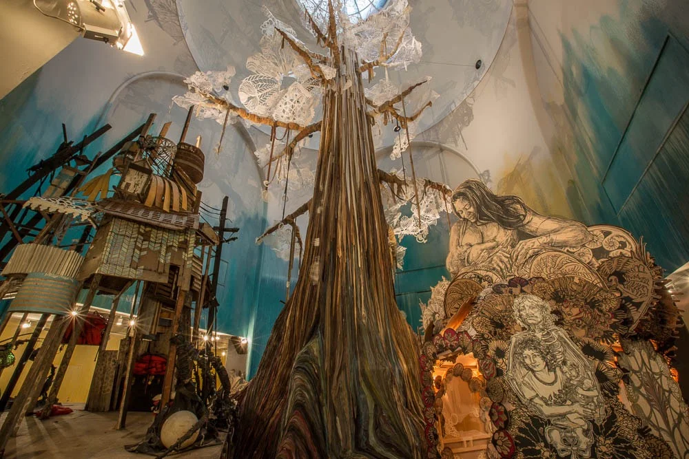 Submerged Motherlands , Swoon’s 2014 solo exhibition at the Brooklyn Museum, was centered about a 65-foot tree made of dyed ribbon and paper cutouts. ( Photo : Tod Seelie) 