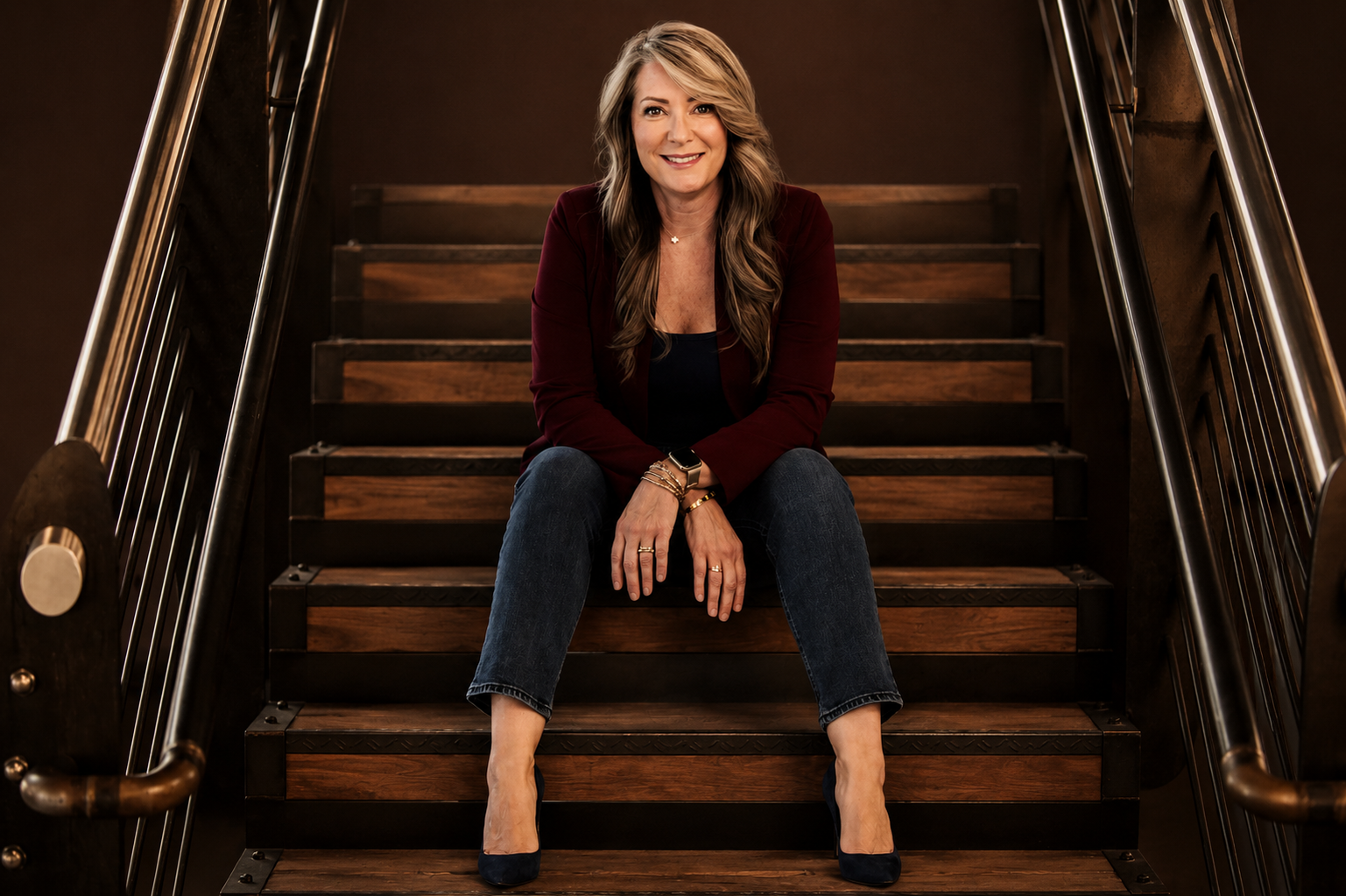 Lori, founder of Co. 1028, seated on a staircase