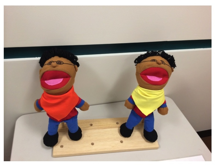 Two puppets expressing their preferences for various foods