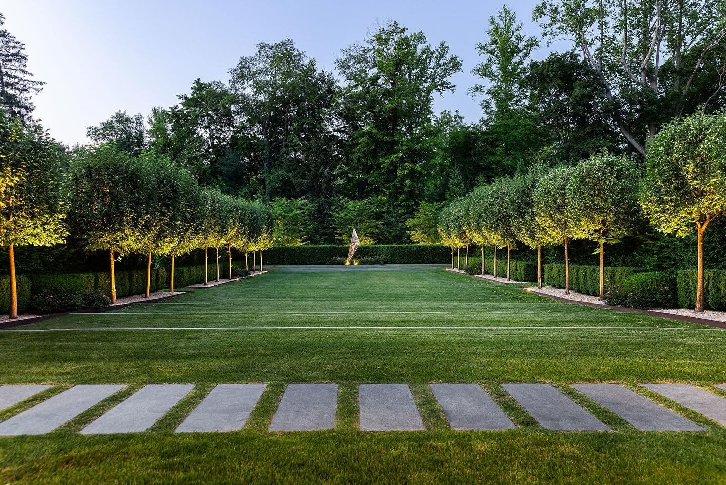 Our formal lawn as seen from the house, presenting an expansive size and featuring a rhythm of layered plantings, sculpture, and lighting. 

Team credits
@cumlaudegroup #sanieearchitects @crina_popescu @robertofernandezlandscaping @summerrainsprinkle