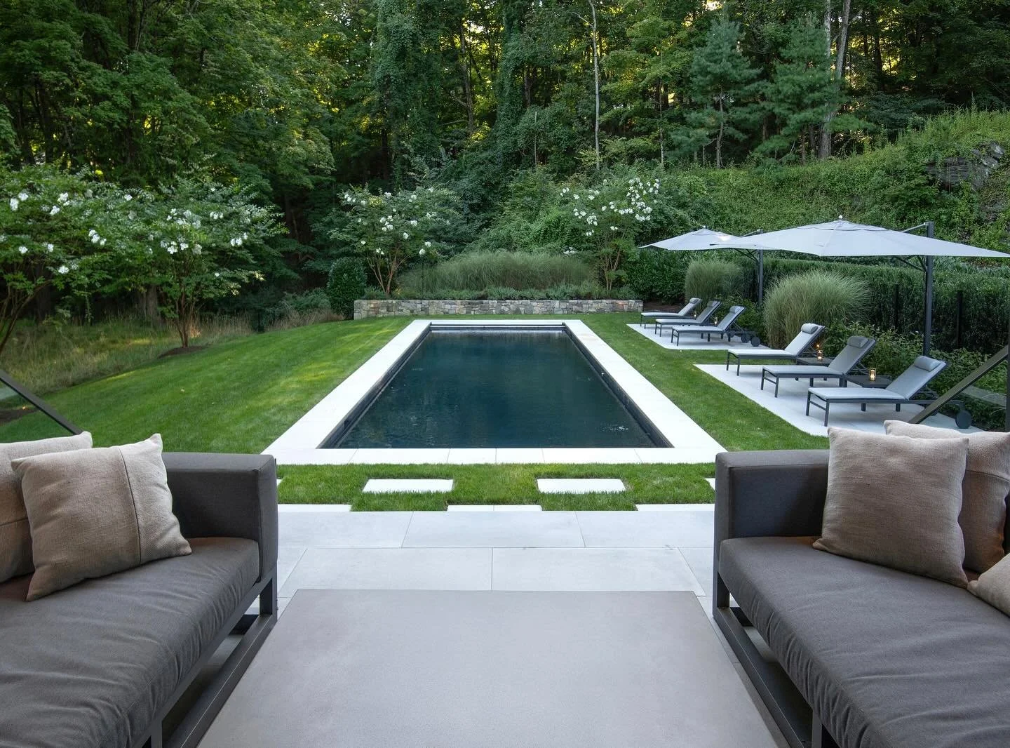 Modern lines, summer Crepe Myrtle blooms, ornamental grasses, and a lawn that flows from meadow to ledge rock &mdash; anchored, balanced, and built for lingering

Team credits:  @cmgbuilder @q_alba_llc @summerrainsprinklers @shorelinepools @ogindustr