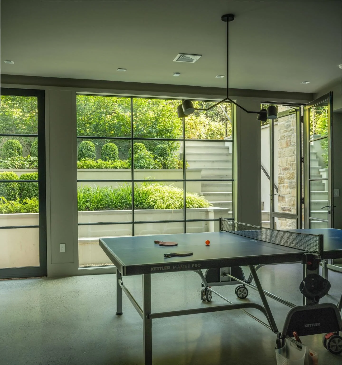 Designed for days spent inside&mdash;without losing the connection to outdoors.
Stepped walls invite light into the lower level rec room and reveal layered planting beyond, creating a quiet dialogue between interior comfort and the garden outside.

P