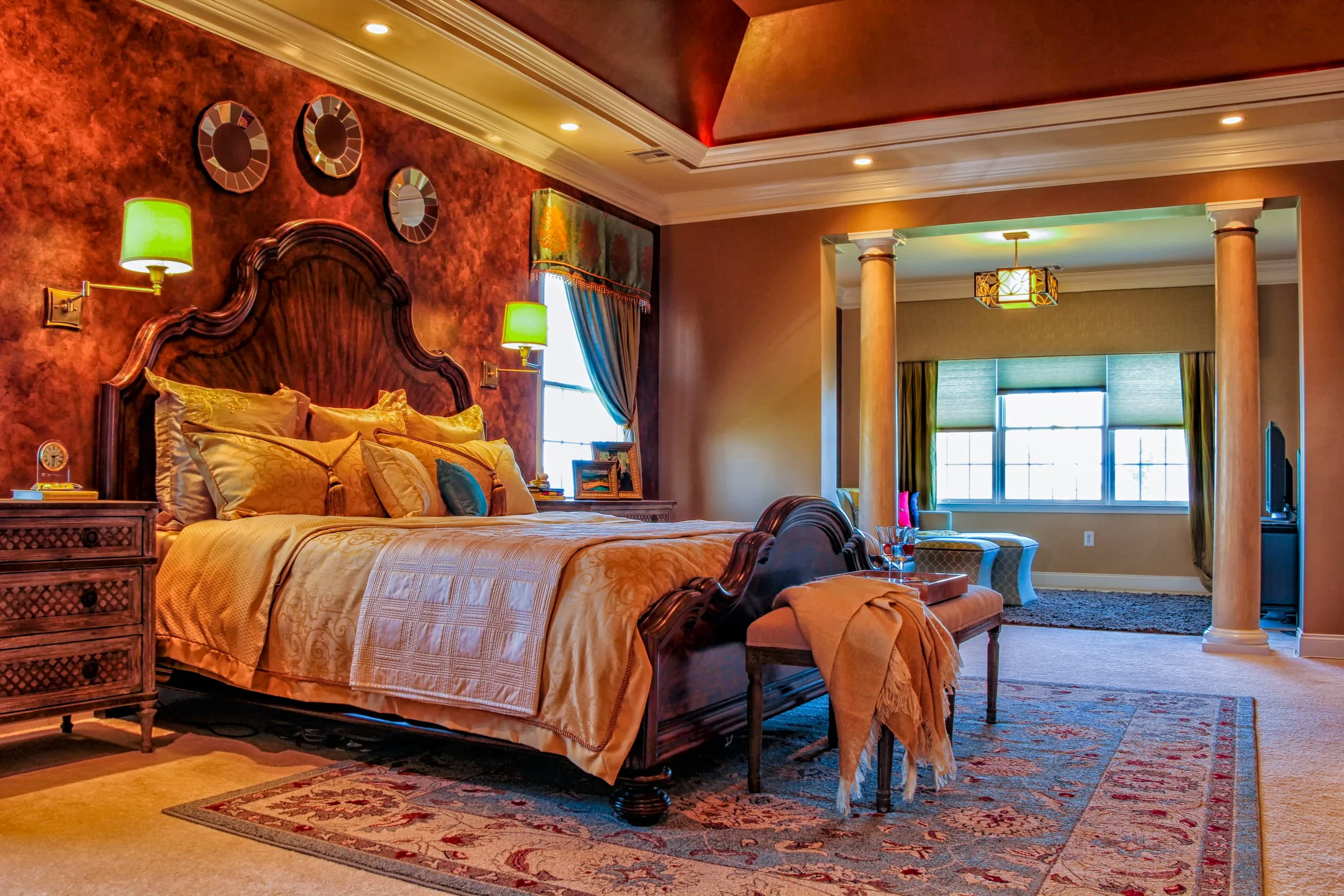 arch wood king sized bed frame in a traditional styled bedroom suite with curated luxury bedding