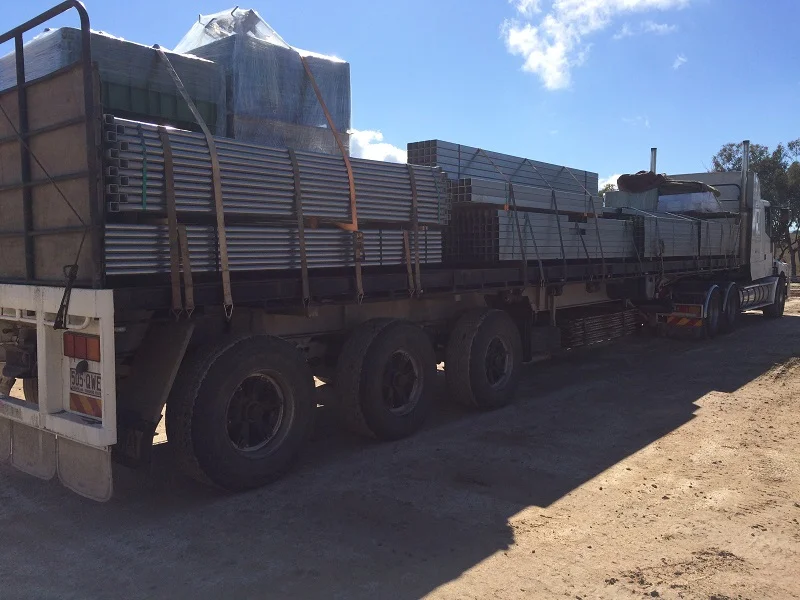 A truck load of panels and gates arriving on site.