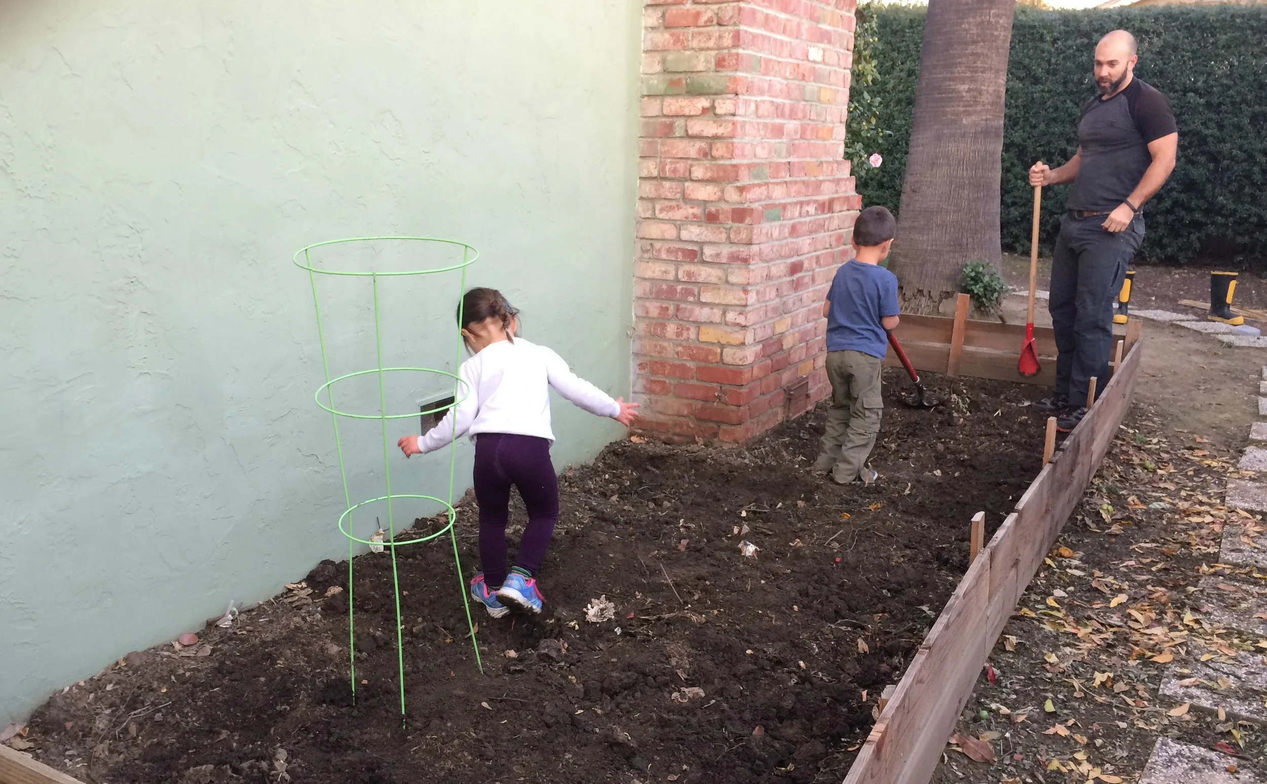 Mixing in our compost into our garden!