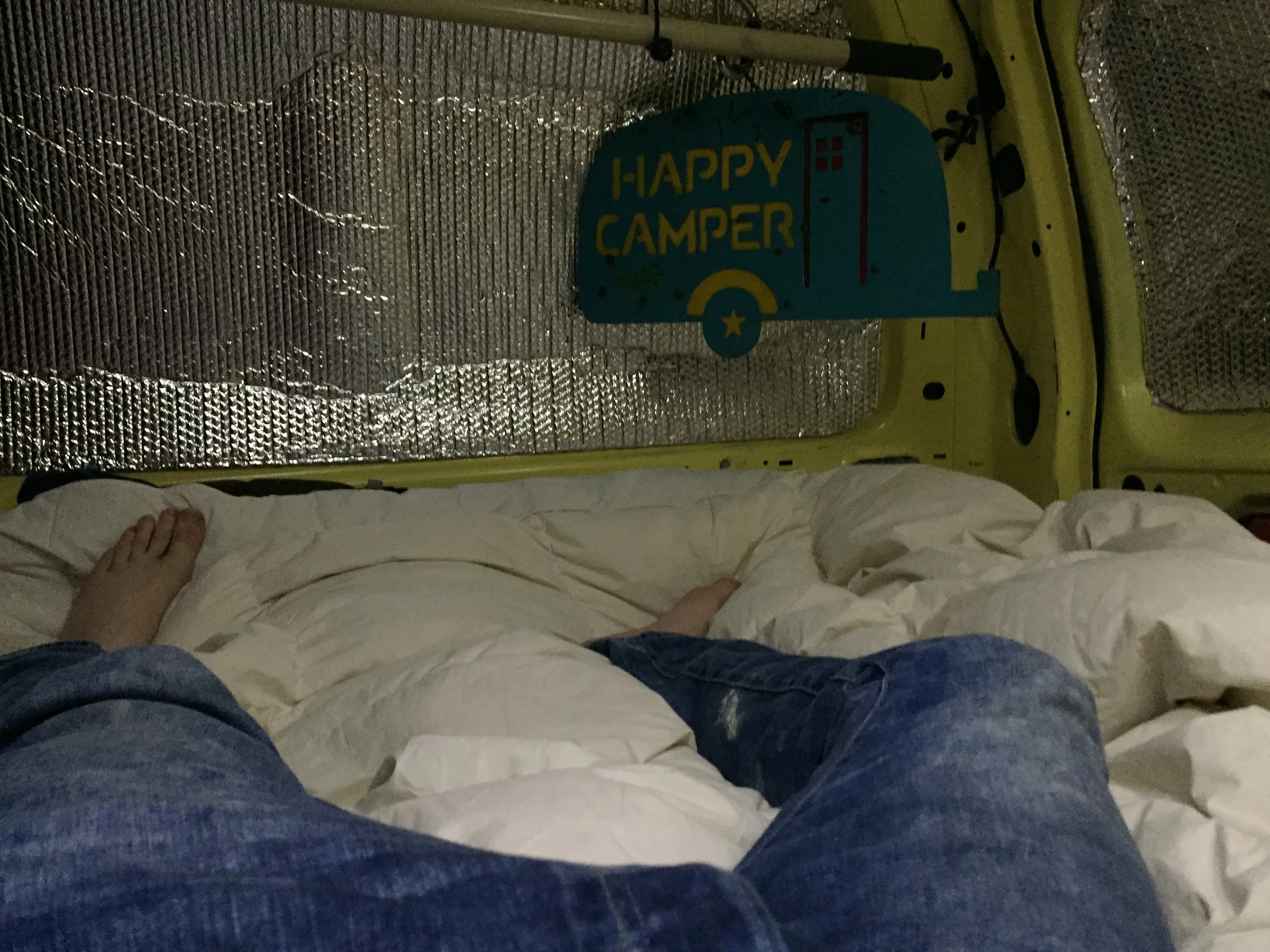 Fully relaxed in a queen sized bed in a van.