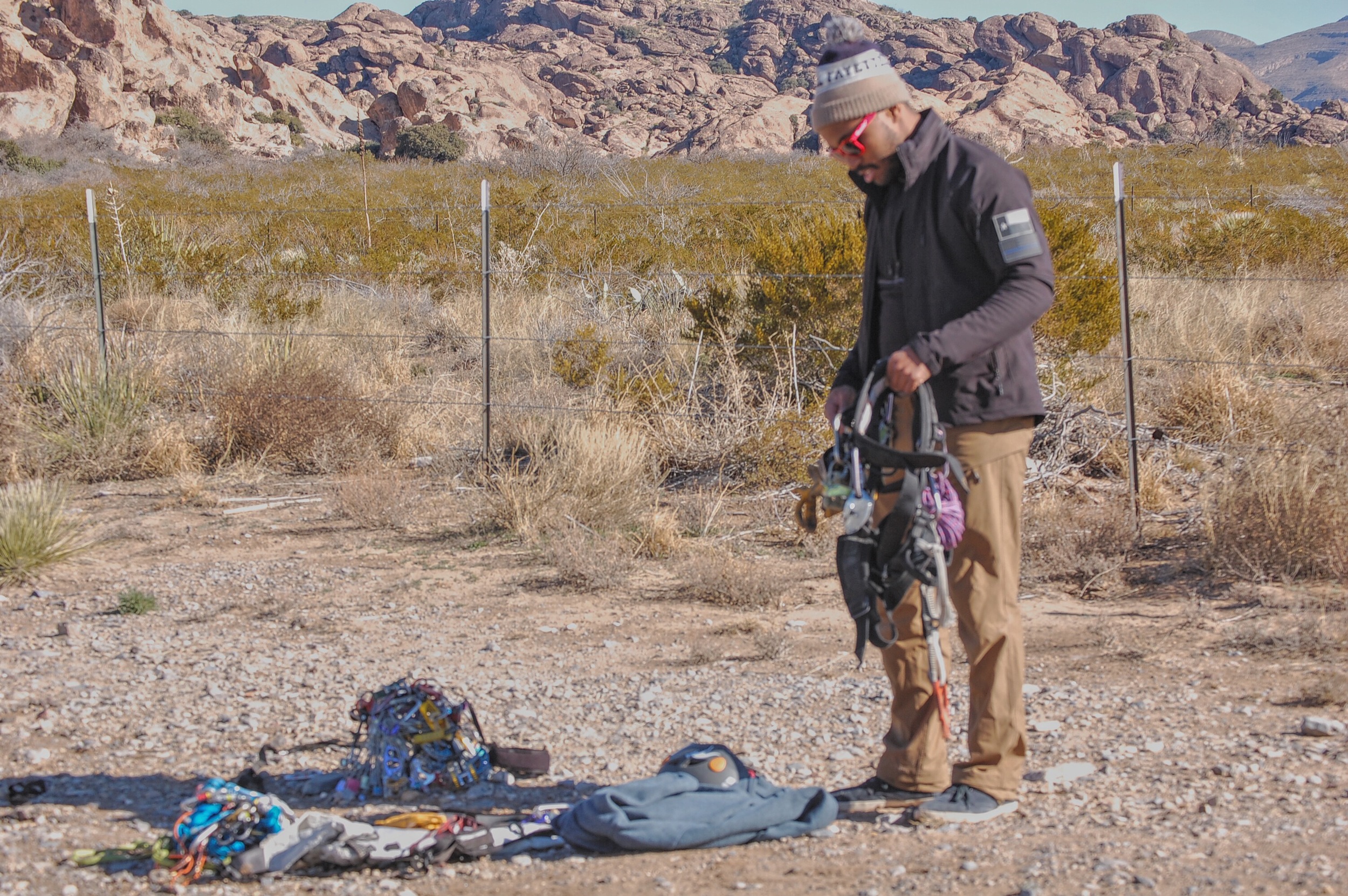 Mario "Racking Up" for some Trad at Hueco Tanks. A small fraction of Mario's gear in a heap on the ground.