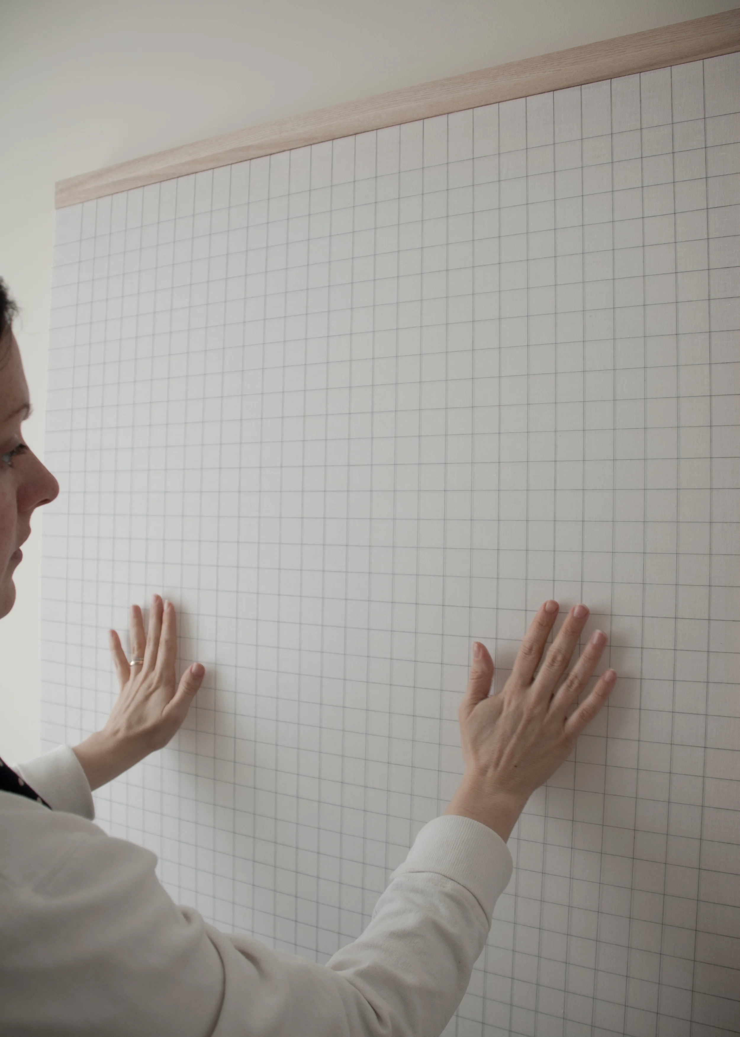 Nicole Patel with The Swiss (2015) White muslin, cotton thread, ashwood bar 32 x 40 in Photo Courtesy of Sweetu Patel