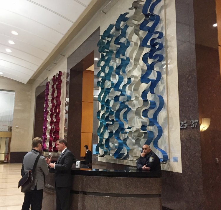 Mayor Walsh stands in front of a commissioned installation in the Bank of America lobby