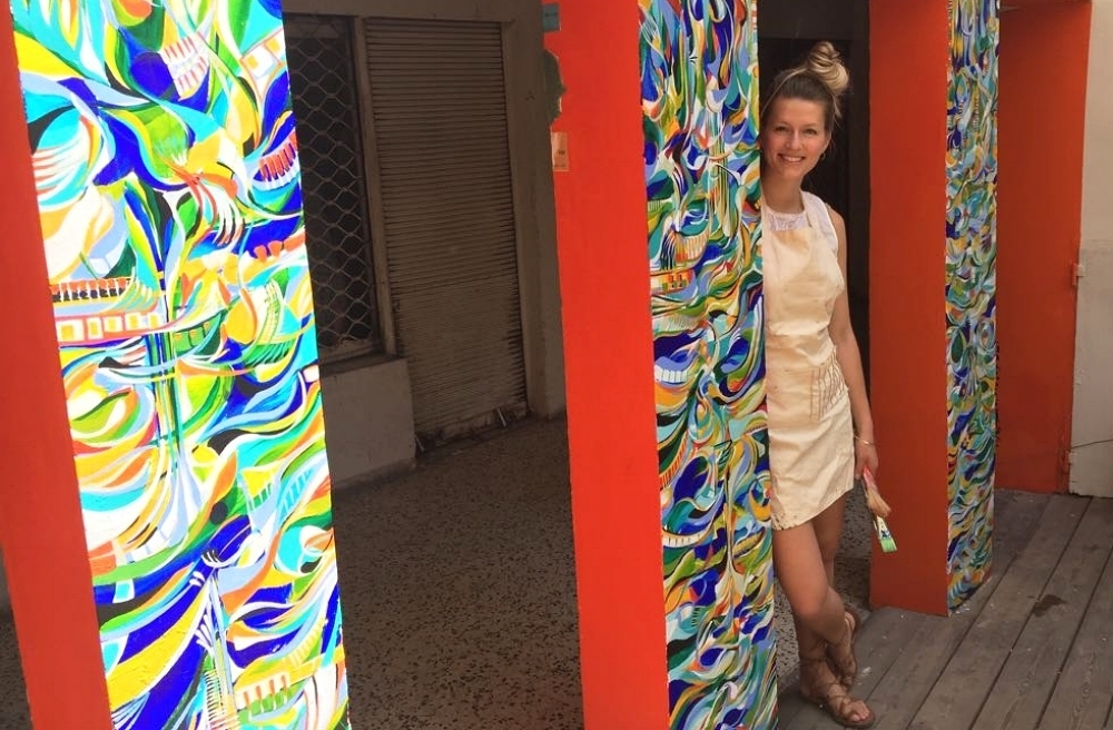 Natalia Wróbel with her mural at the Rena House, in Tel Aviv, Israel, image courtesy of the artist