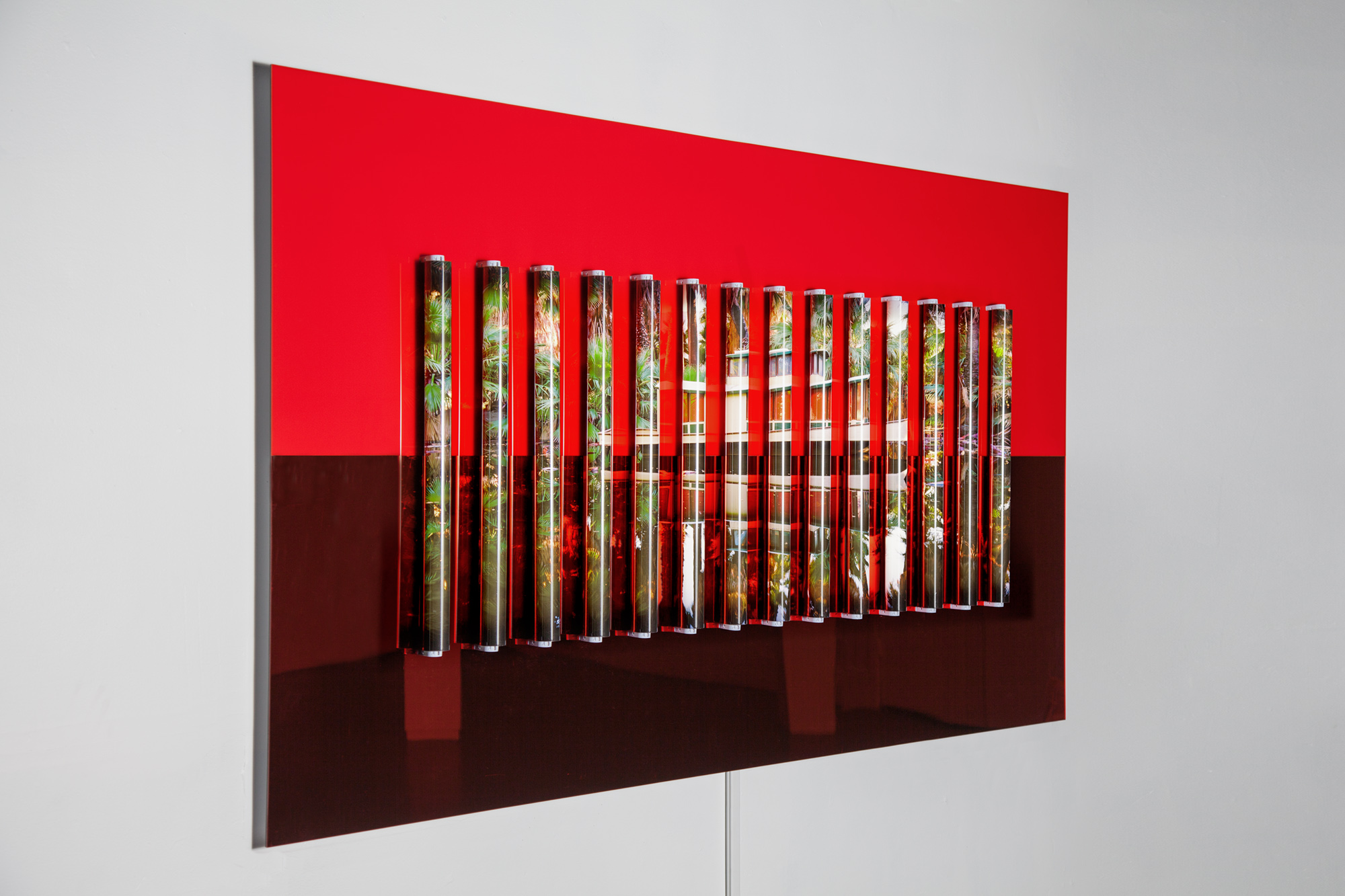 Clint Baclawski, Oasis, 2017. Glossy red Plexiglas and red mirrored Plexiglas on Dibond, archival pigment backlight prints, clear polycarbonate tubes, 2′ LED bulbs 44 x 80 x 3 in.