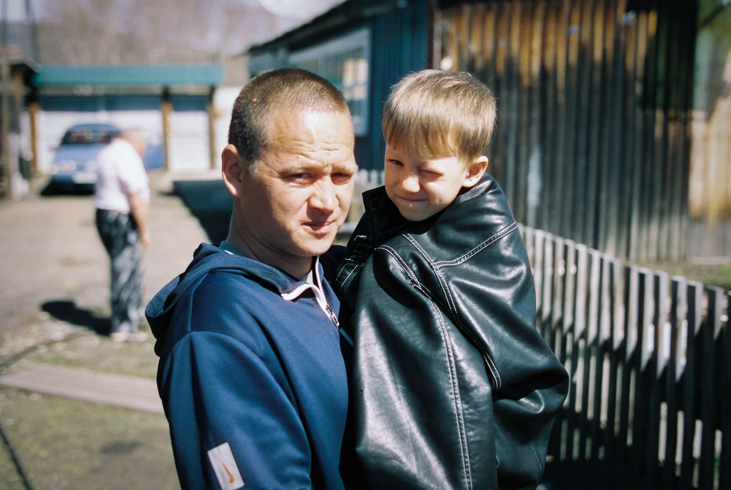 Nikolay is keeping his son warm under his jacket. Photo: Contax 645 + Kodak
