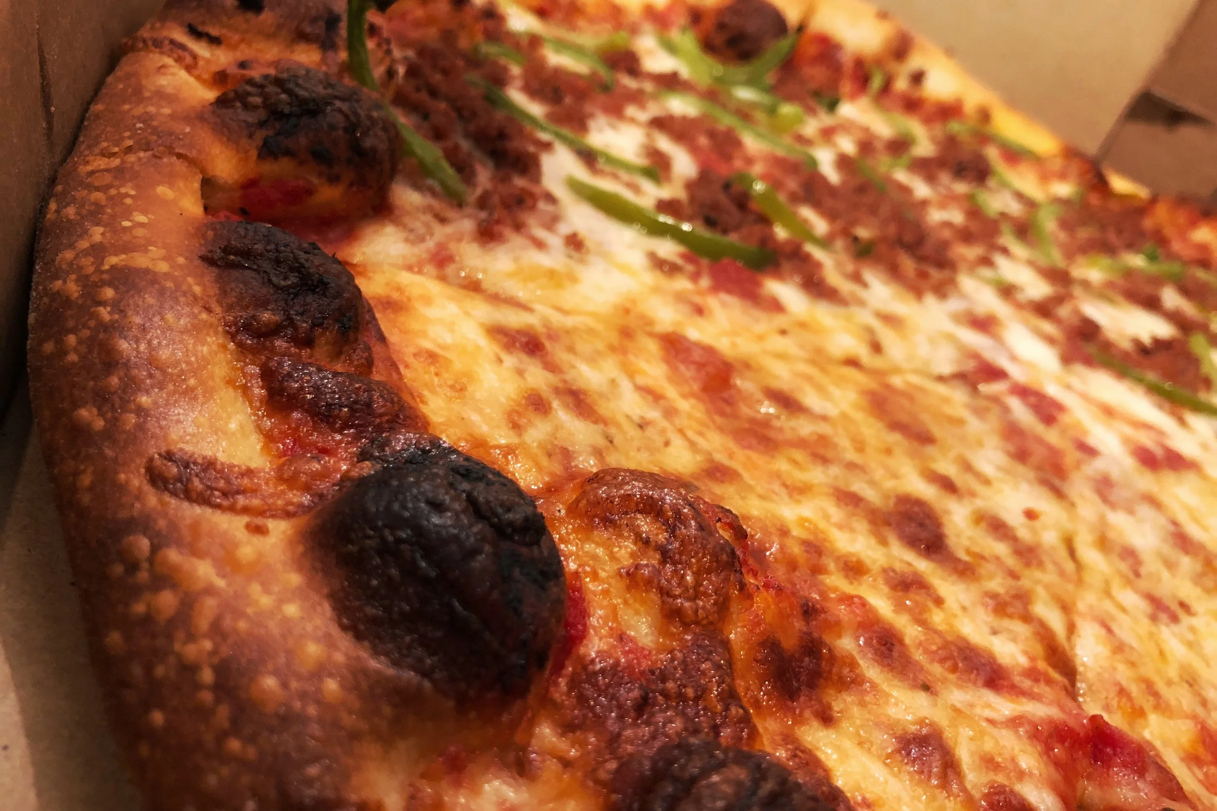 Above you can see a practically perfect in every way pizza. The crust is the right kind of brown, charred in the right spots, and you have an even layer of cheese that covers the sauce just so. 