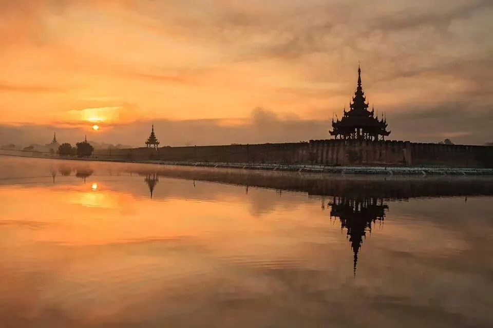 Sunset at the Mandalay Grand Palace Mandalay palace is surrounded by a moat and creates an awesome reflection during sunset or sunrise.