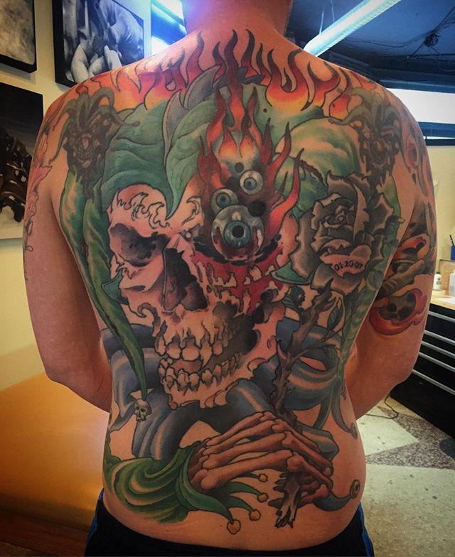 Started this back piece years ago. Finally done! There's a coverup in the center and he already had the two small jester heads. #tattoo #artcore #jester #skulltattoo #ouchmyeye