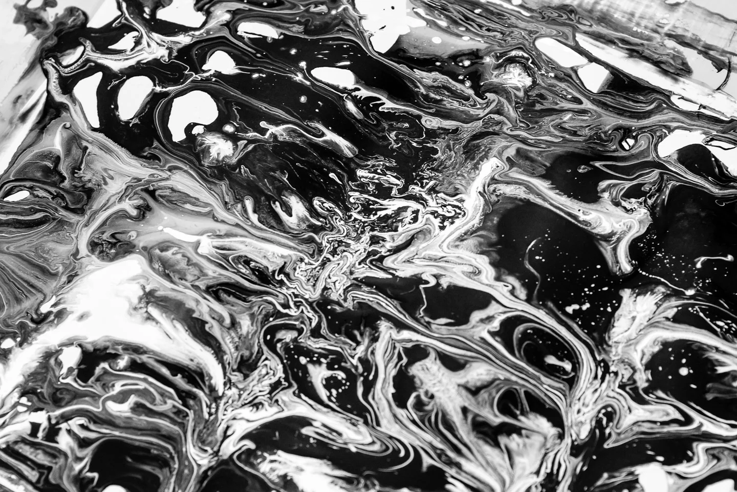 Pattern made by pouring and mixing paint on paper