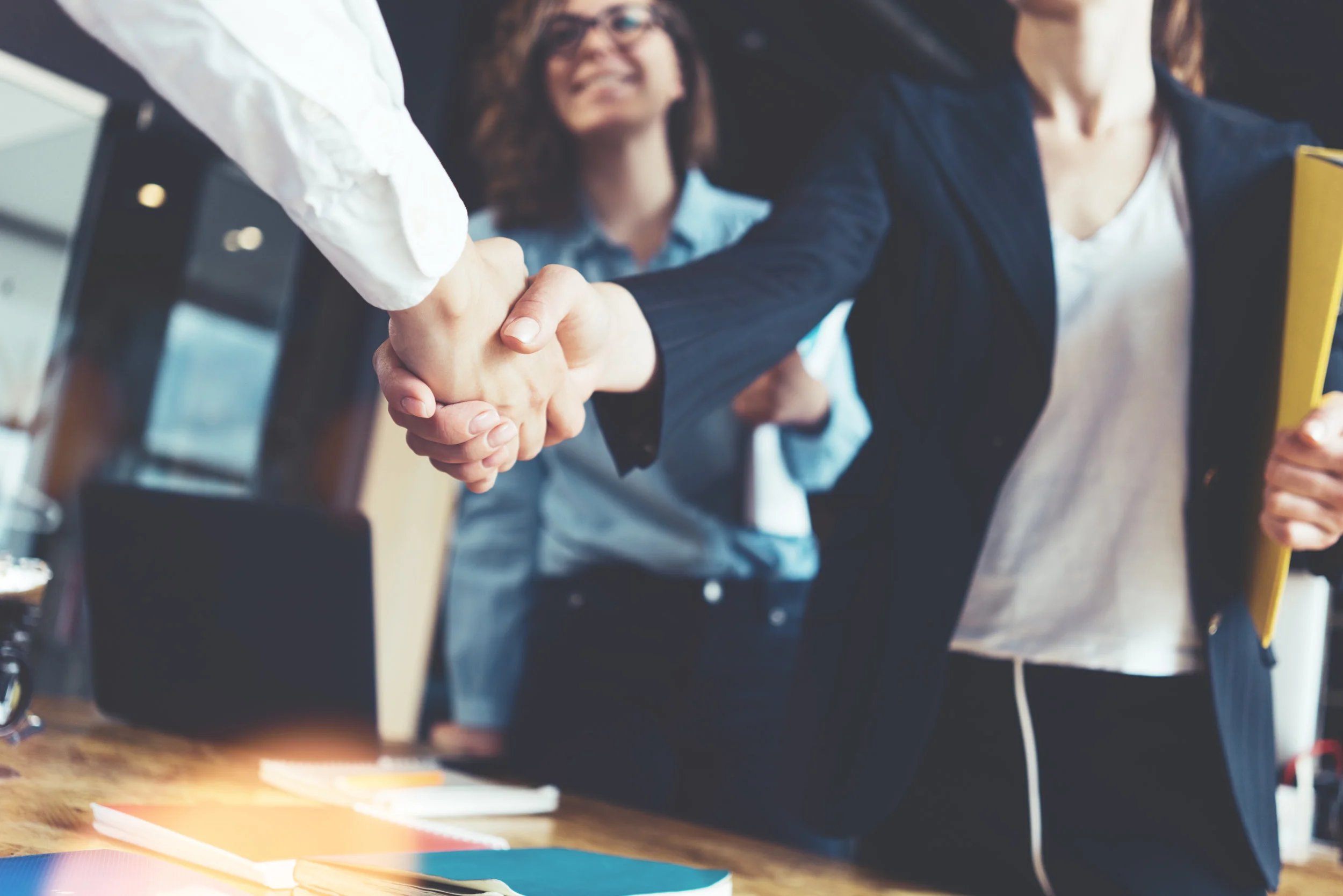 oung business people shaking hands in the office. Finishing successful meeting. AdobeStock_158504099.jpeg