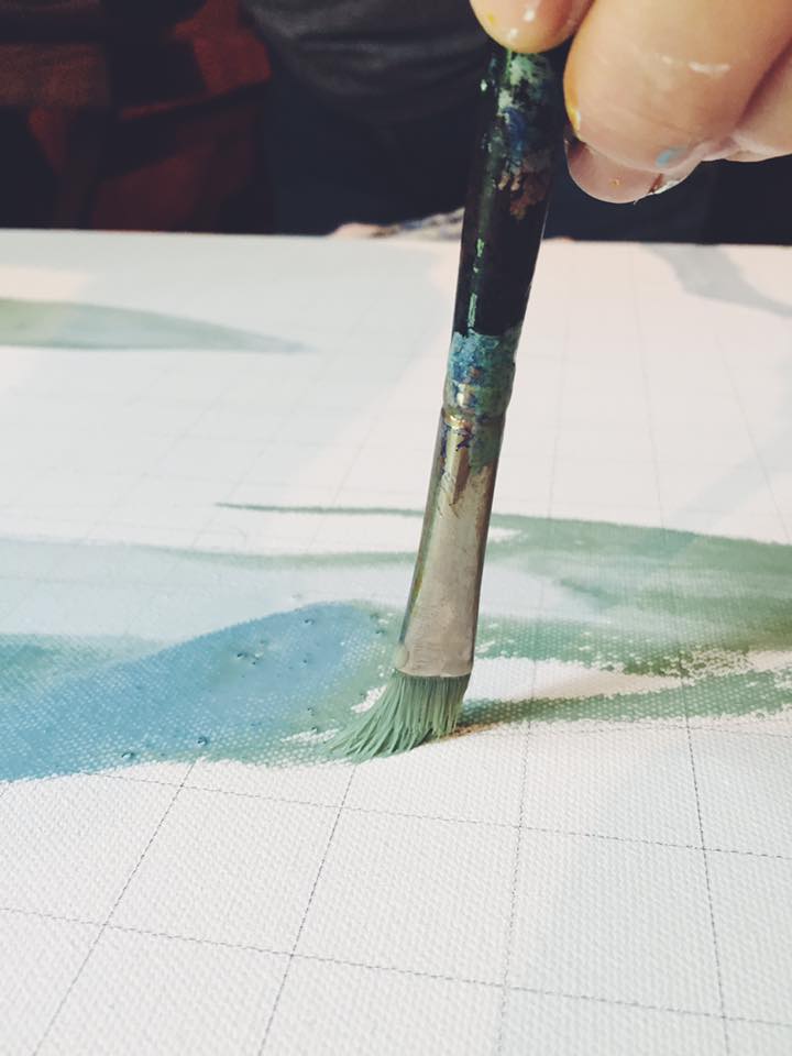 After gridding and placing the basic shapes on the canvas, I water down my acrylic mixes and put down a wash of colors. When it dries, I'll be ready to pixel the entire image.