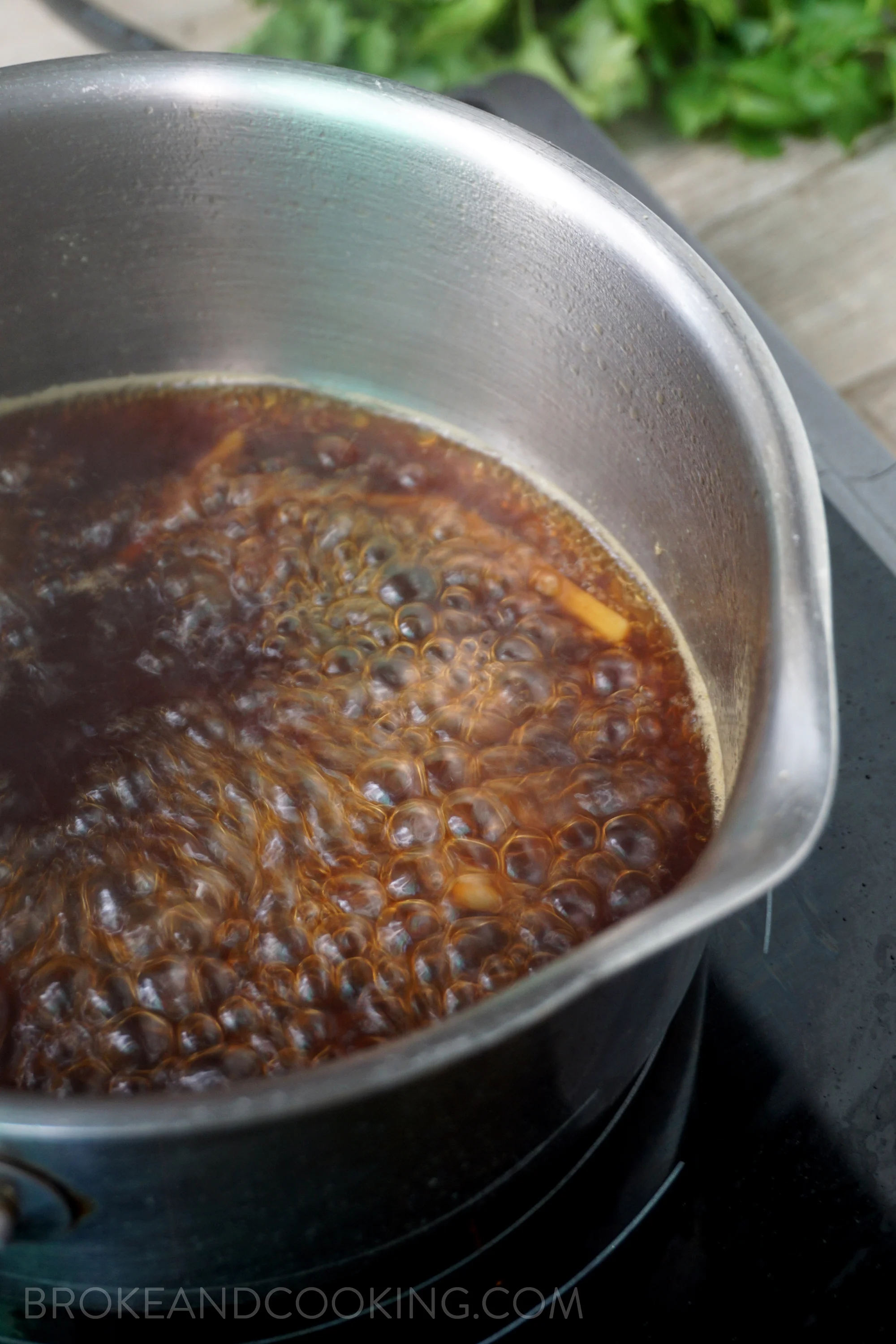 Adding soy, sesame oil, jalapeño, green onion, and lemon juice to the poaching liquid is perfect for simmering down to a delicious sauce for the poached salmon. 