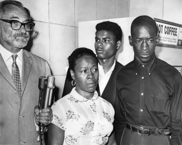 Attorney A. L. Wirin, left, with Mrs. Rena Frye, accused of interfering with officers who arrested her sons, Ronald, center, and Marquette, right. Photograph via L.A. Times (1965)