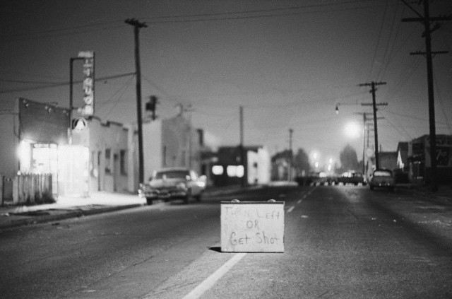 Although law and order have been re-established in the strife-torn Watts district of Los Angeles, this sign remains as a terrifying symbol of the events that passed. As a further sign of peace, Governor Edmund G. Brown ended 8/17 the curfew forbidding people from being on the streets after dark. Bettmann/CORBIS (1965)