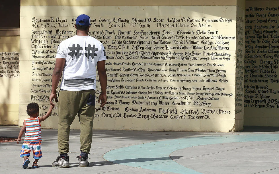 Nickerson Gardens resident Jon Perkins, 21, and his 1-year-old son L.A. Times
