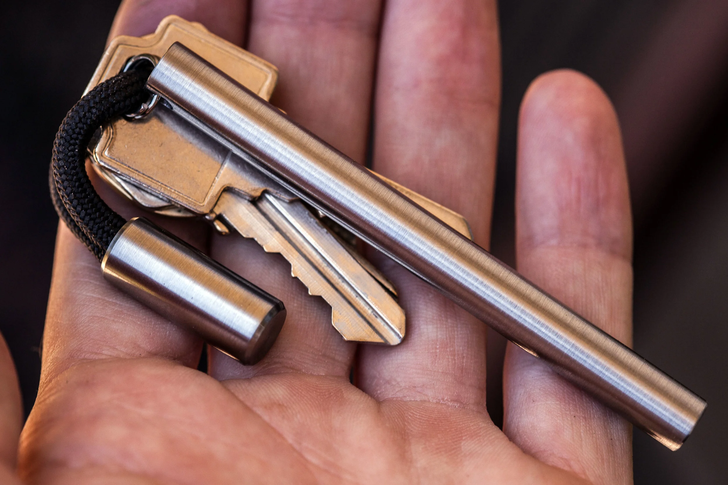 Titanium Cord Lock keychain in use, shown with the titanium EDC Ink keychain pen.