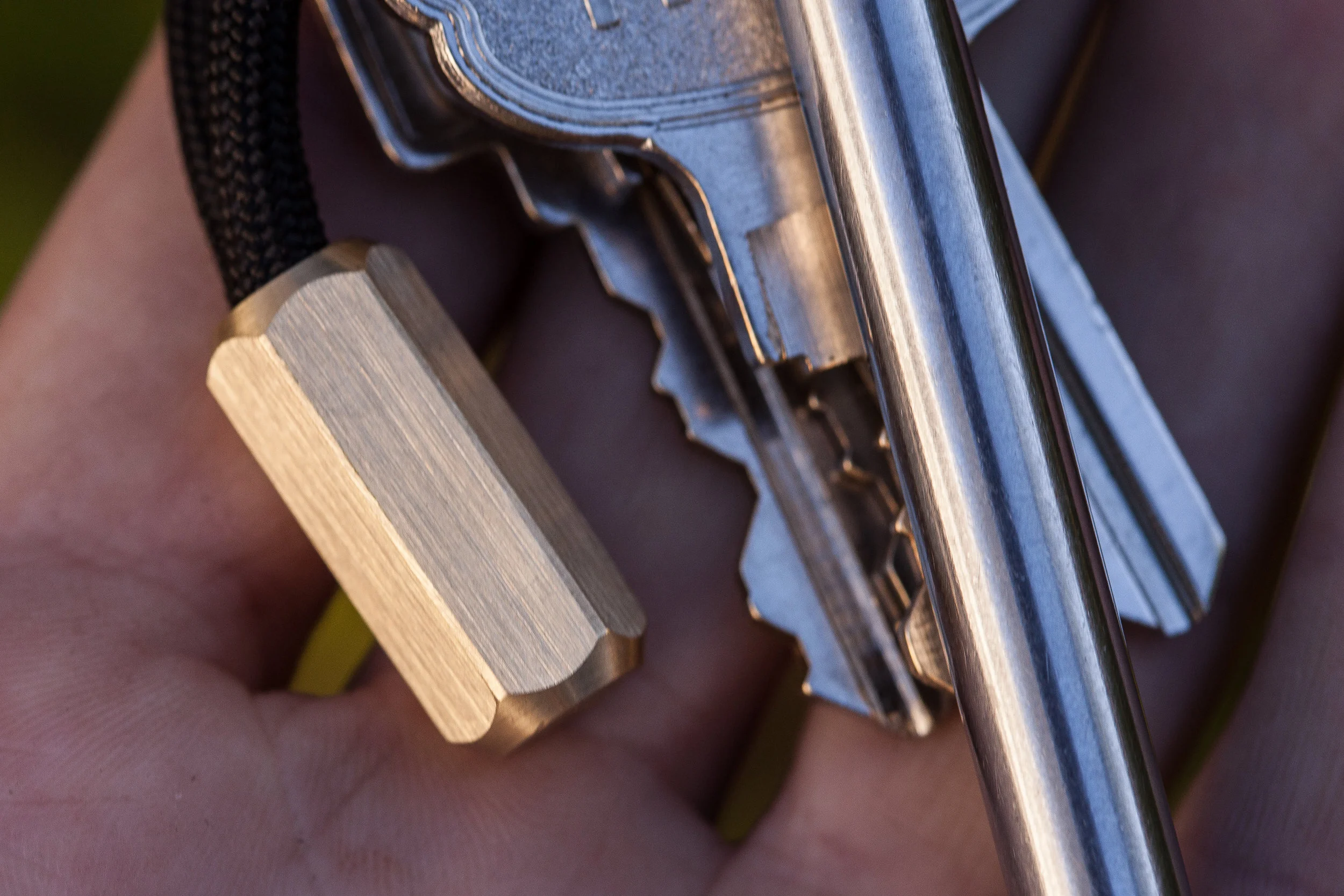 Close up detail of the surface finish of the brass hex version of the Cord Locks for 550 paracord - shown with the titanium EDC Ink pen.