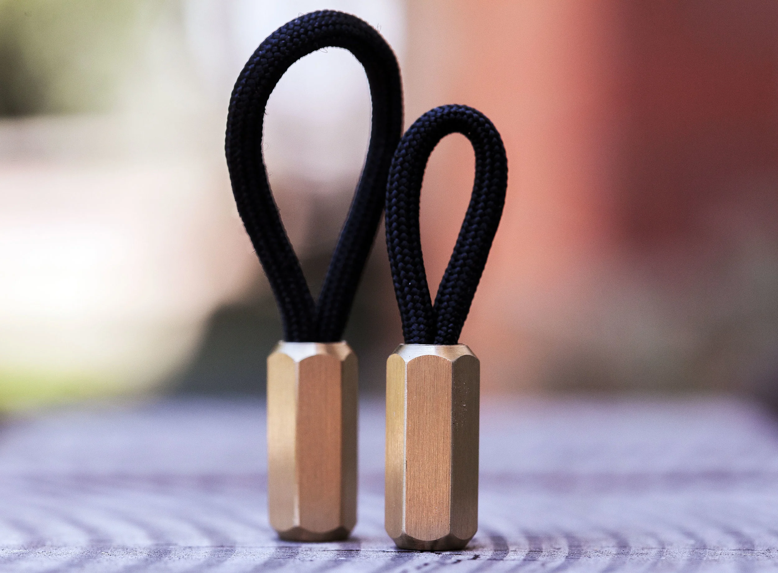 The brass hex version of the Cord Locks shown with black 550 paracord.