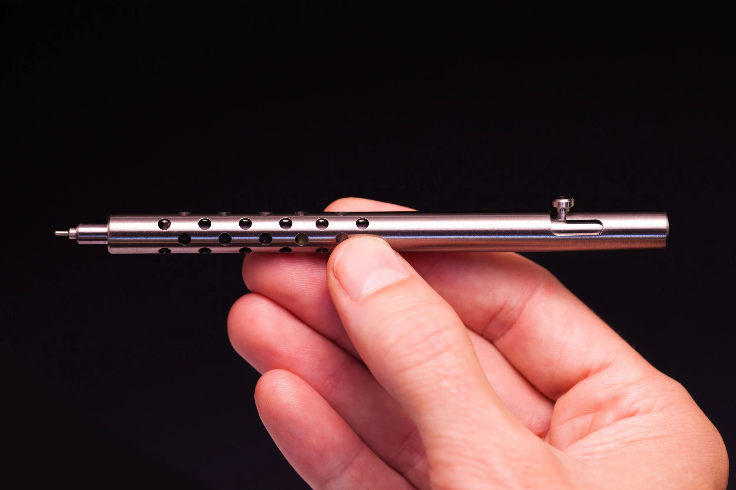 Holding the Silencer version of the Injector titanium bolt action pen in one hand.