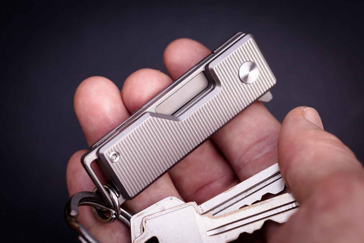 EDC Titanium Pocket Tanto keychain knife shown in hand with blade closed.