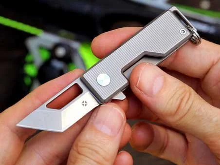 Vector version of the Pocket Tanto EDC Keychain knife with the blade fully open held in hands.