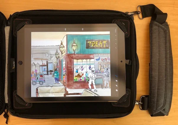 iPad in Etchr Slate Art Bag. The ipad is held in the bag with corner fasteners allowing one to sketch while standing up with the included should strap.