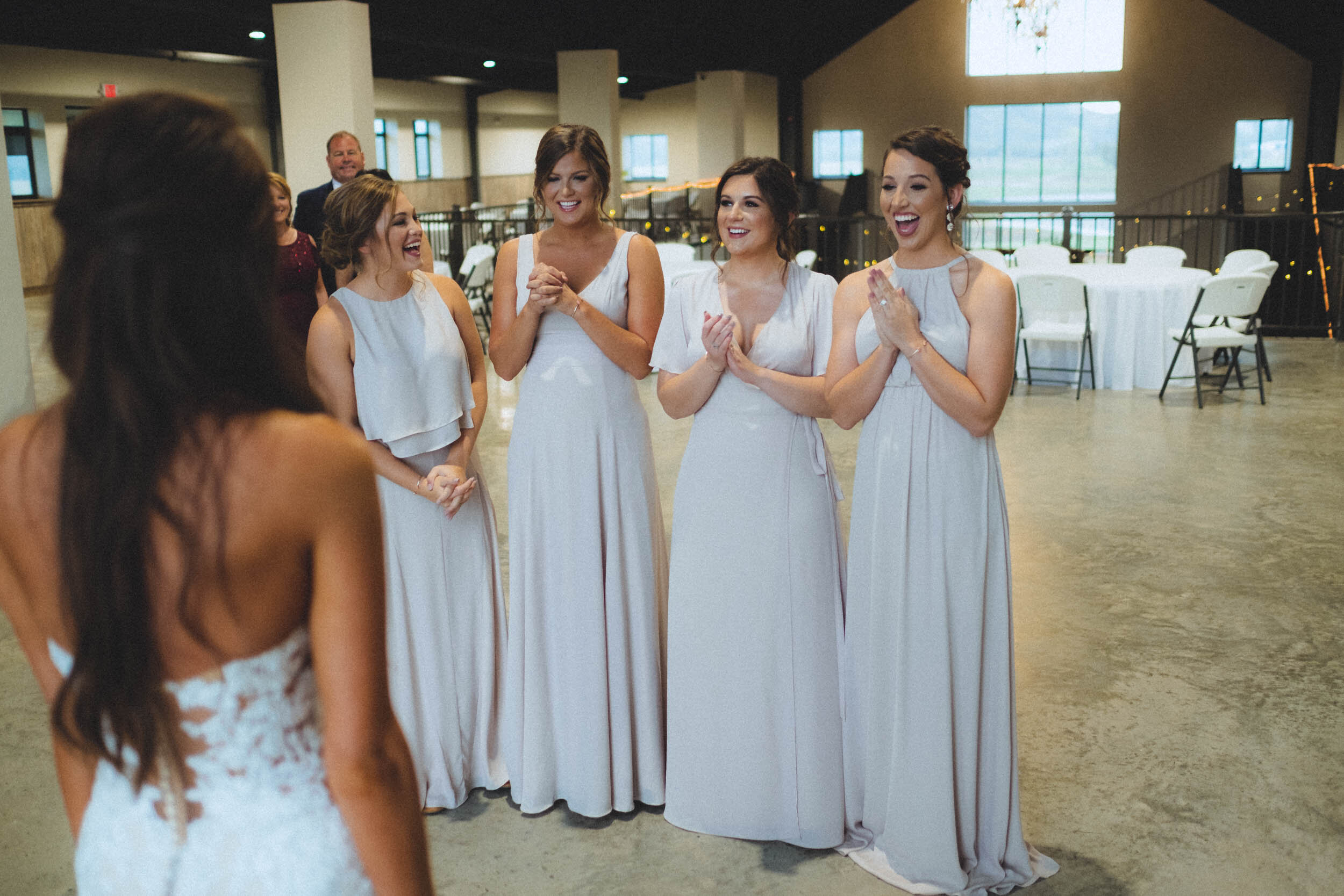 Bride revealing her Dress to her bridesmaids