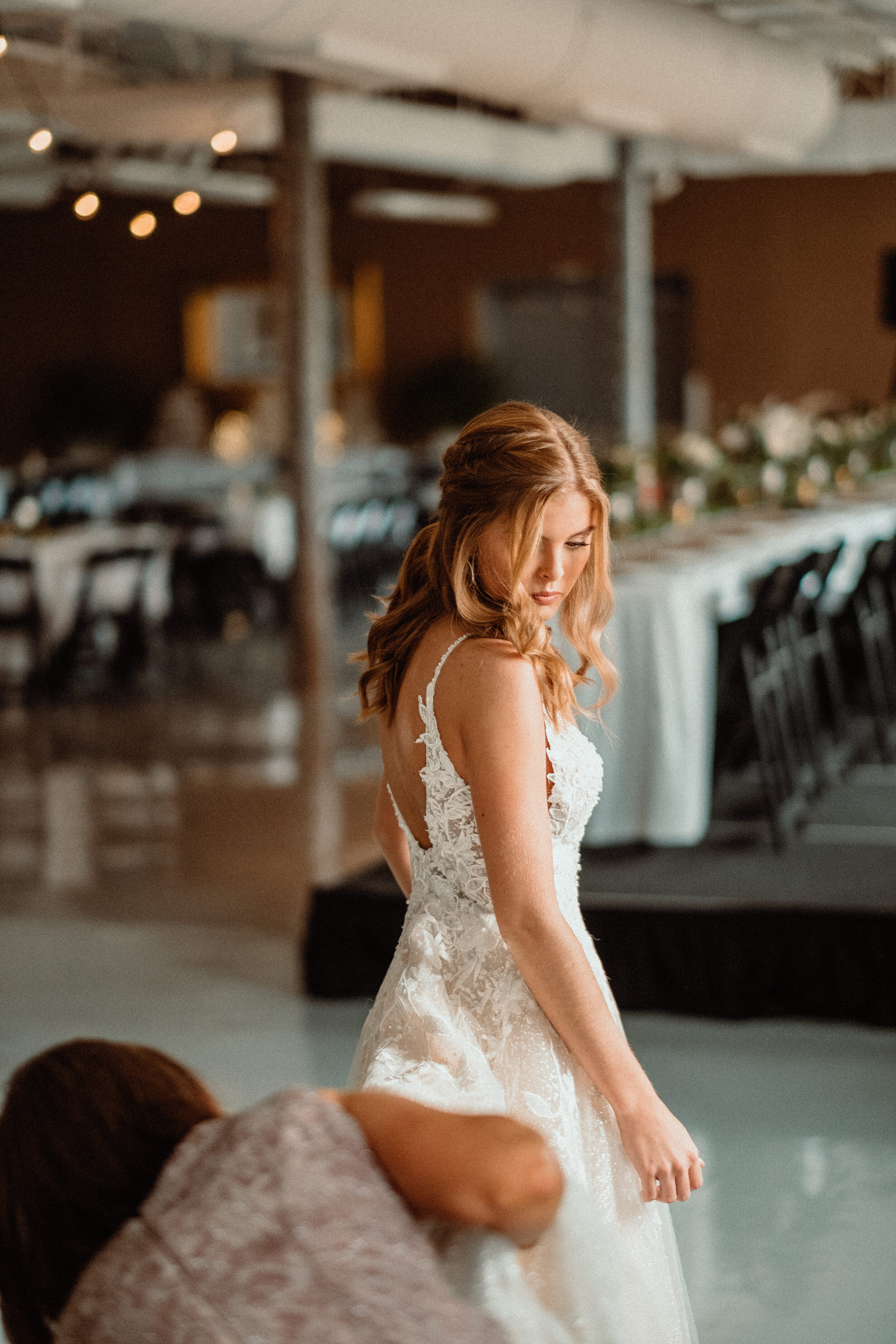 Bride getting dress on natural light at Maytag Event Complex