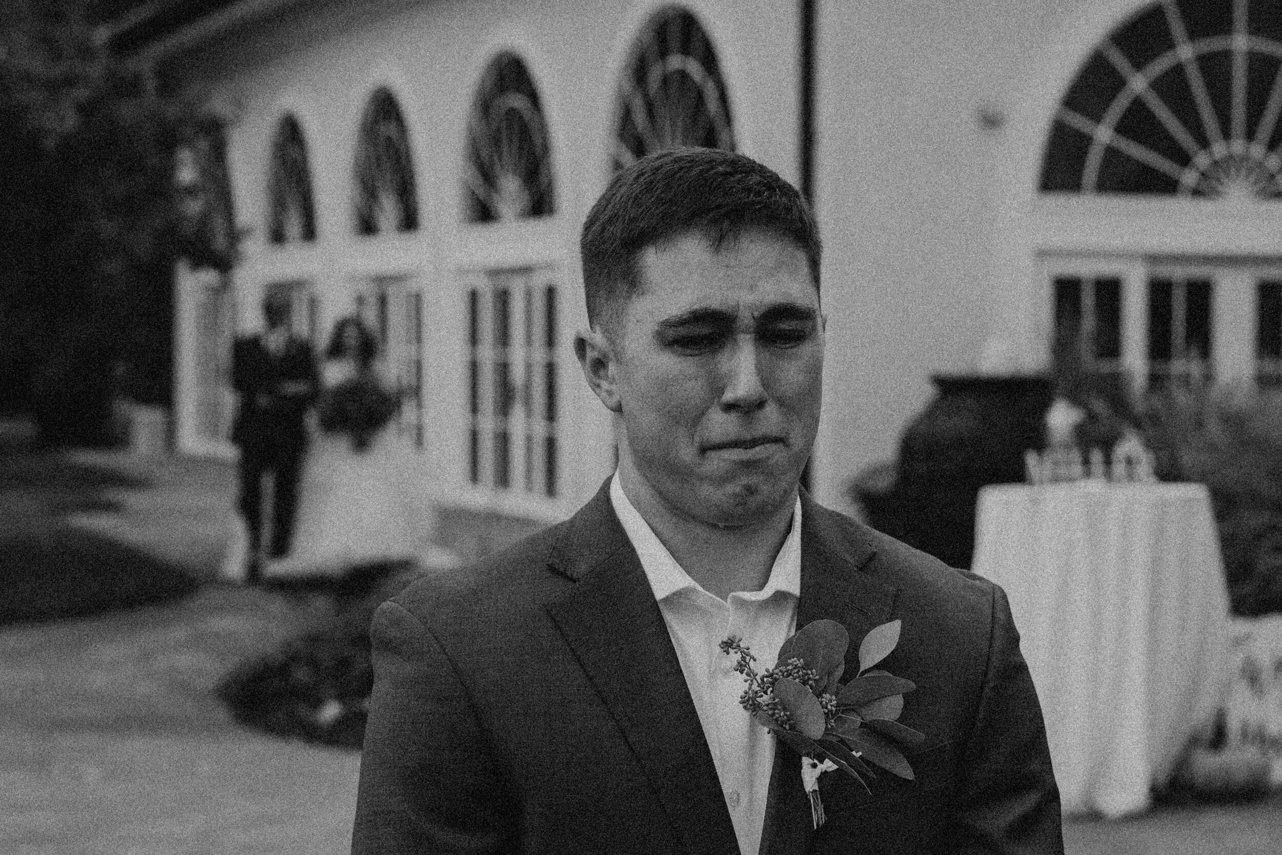 groom crying as bride walks down the aisle