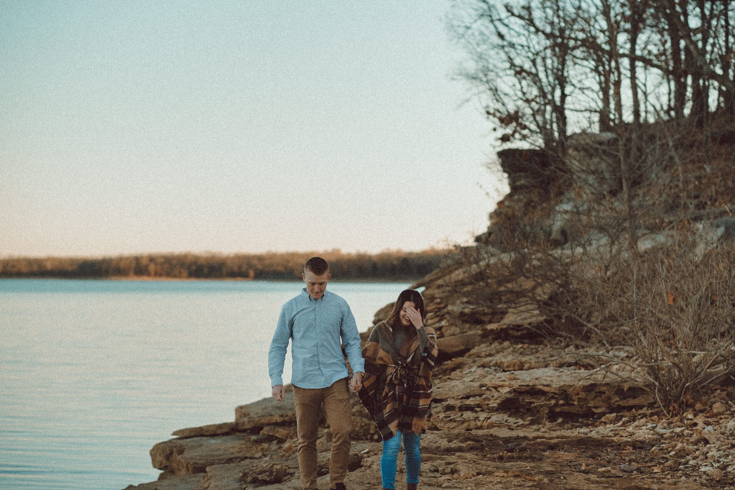 Couple walking on Stockton Lake for engagement photos